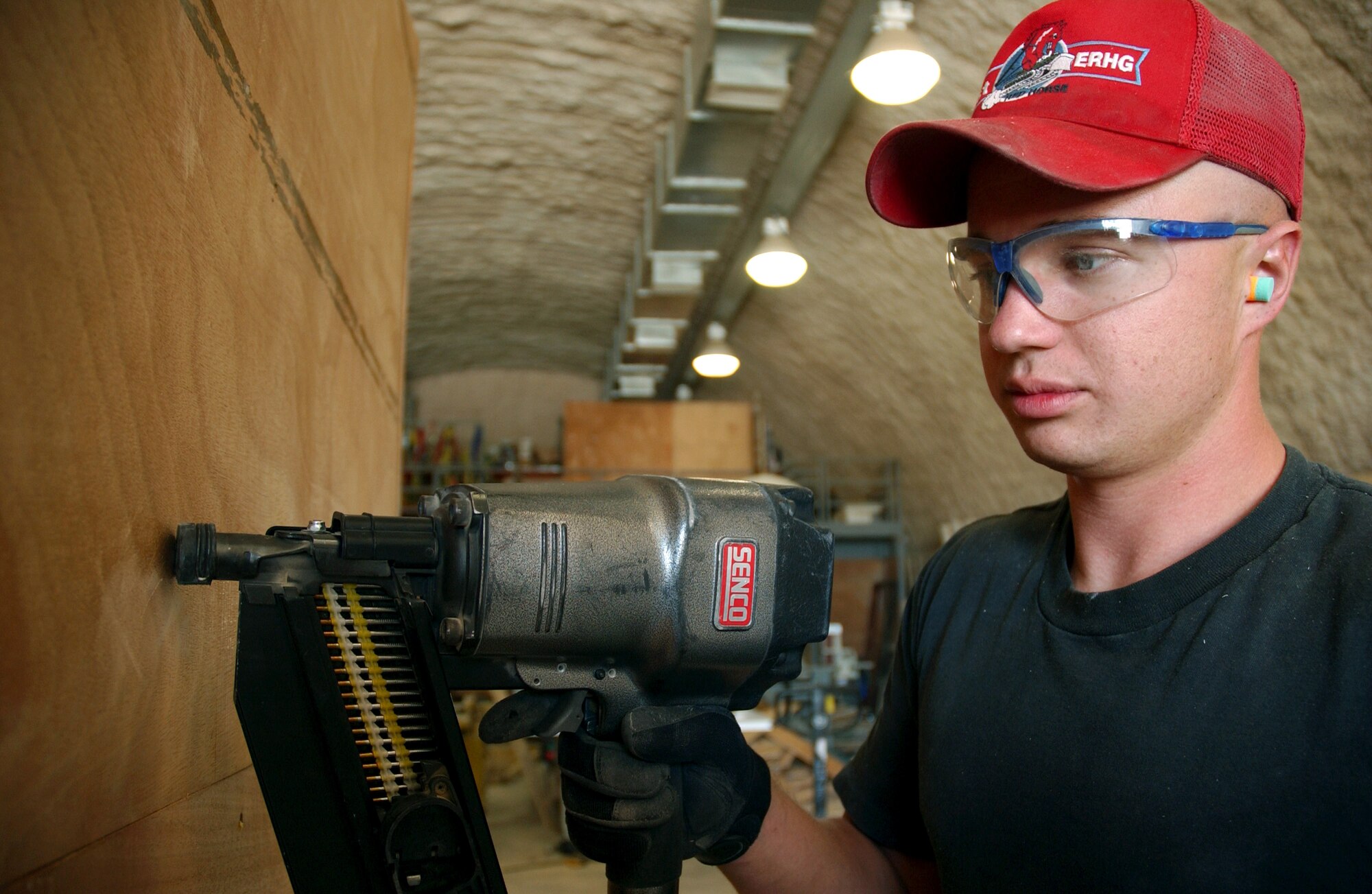 Staff Sgt. Benjamin Jensen builds baggage crates at the passenger terminal at a deployed location in southwest Asia, March 8, 2006. The crates are used to transport the baggage of forward deploying servicemembers. Sergeant Jensen is assigned to the 379th Expeditionary Civil Engineer Squadron. He is deployed from Mountain Home Air Force Base, Idaho. (U.S. Air Force photo/Airman 1st Class Anthony Nelson Jr.)