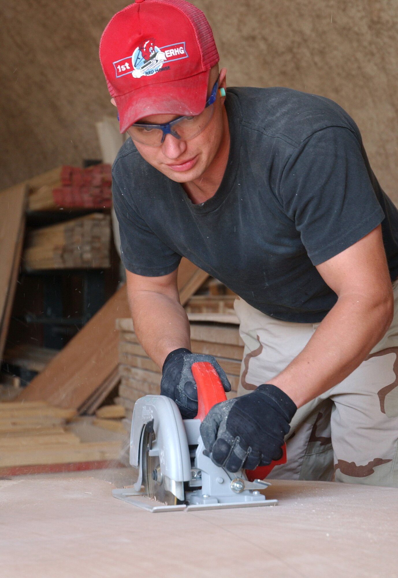 Staff Sgt. Benjamin Jensen builds baggage crates at the passenger terminal at a deployed location in southwest Asia, March 8, 2006. The crates are used to transport the baggage of forward deploying servicemembers. Sergeant Jensen is assigned to the 379th Expeditionary Civil Engineer Squadron. He is deployed from Mountain Home Air Force Base, Idaho. (U.S. Air Force photo/Airman 1st Class Anthony Nelson Jr.)