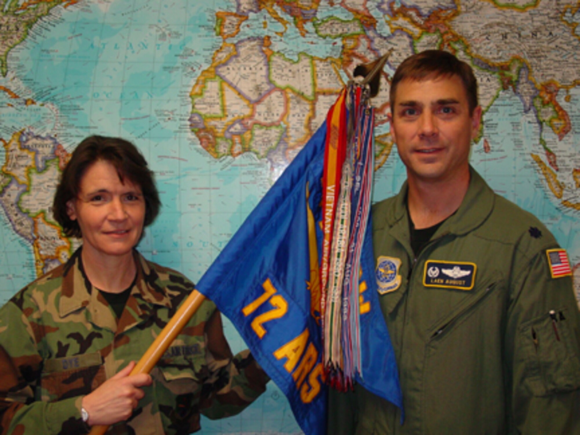 Lt. Col. Laen August, commander of the 72nd Air Refueling Squadron, and Senior Master Sgt. Sandy Dye, first sergeant, pose with the unit's flag which now has all of its earned campaign streamers attached.  The 72nd ARS is located at Grissom Air Reserve Base, Ind.  (U.S. Air Force photo by SrA Vicki Cummings)