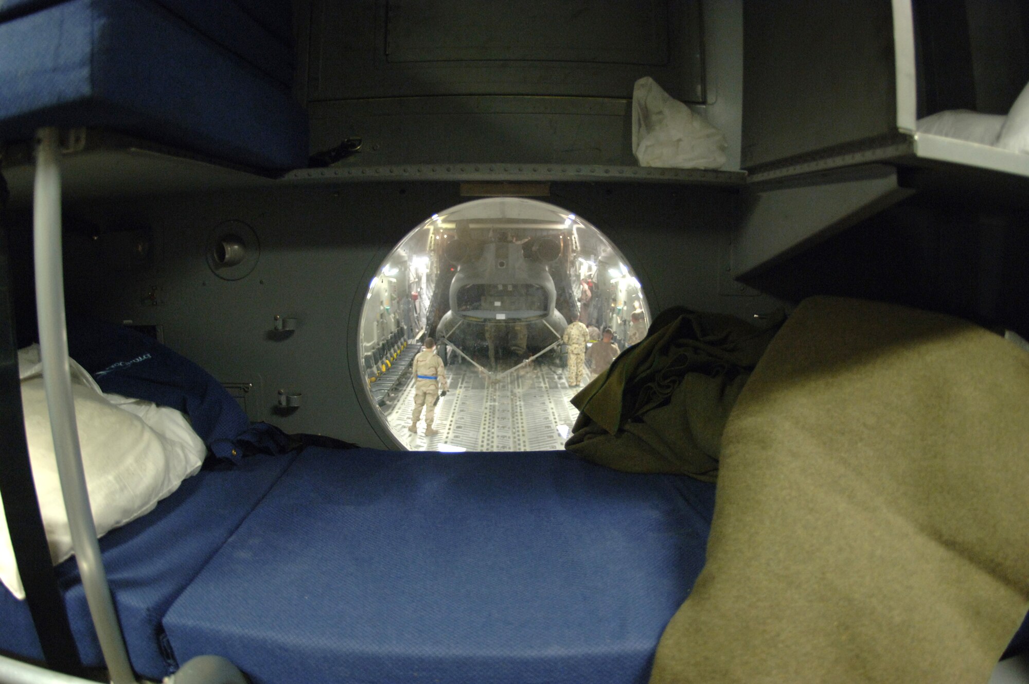 Crewmembers from the 817th Expeditionary Airlift Squadron and their Australian forces counterparts upload an Australian Army CH-47 helicopter onto a C-17 Globemaster III at a deployed location in Southwest Asia on Sunday, Mar. 12, 2006. The C-17 is from McChord Air Force Base, Wash. (U.S. Air Force photo/Staff Sgt. Joshua Strang) 