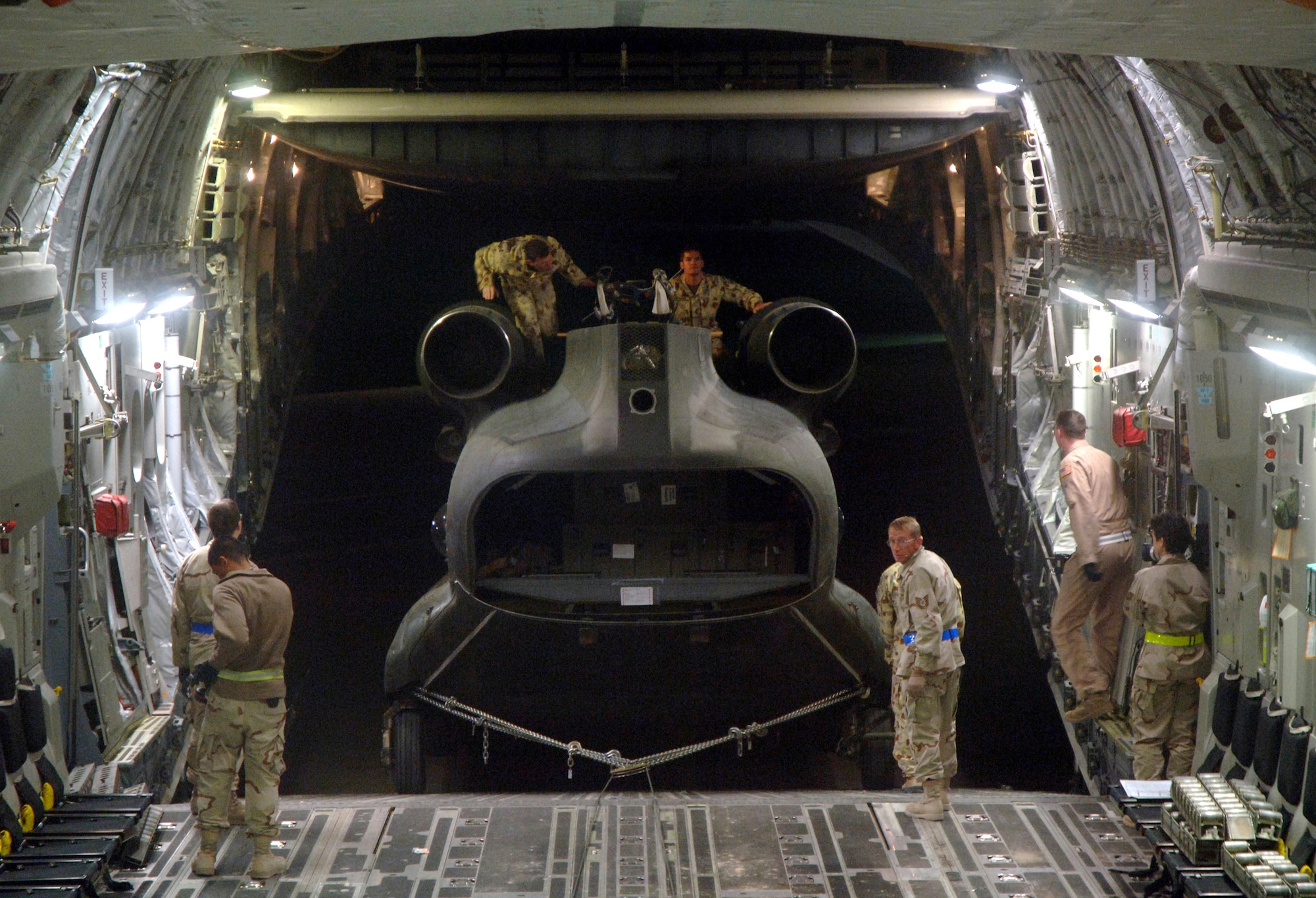 Crewmembers from the 817th Expeditionary Airlift Squadron and their Australian forces counterparts upload an Australian Army CH-47 helicopter onto a C-17 Globemaster III at a deployed location in Southwest Asia on Sunday, Mar. 12, 2006. The C-17 is from McChord Air Force Base, Wash. (U.S. Air Force photo/Staff Sgt. Joshua Strang) 