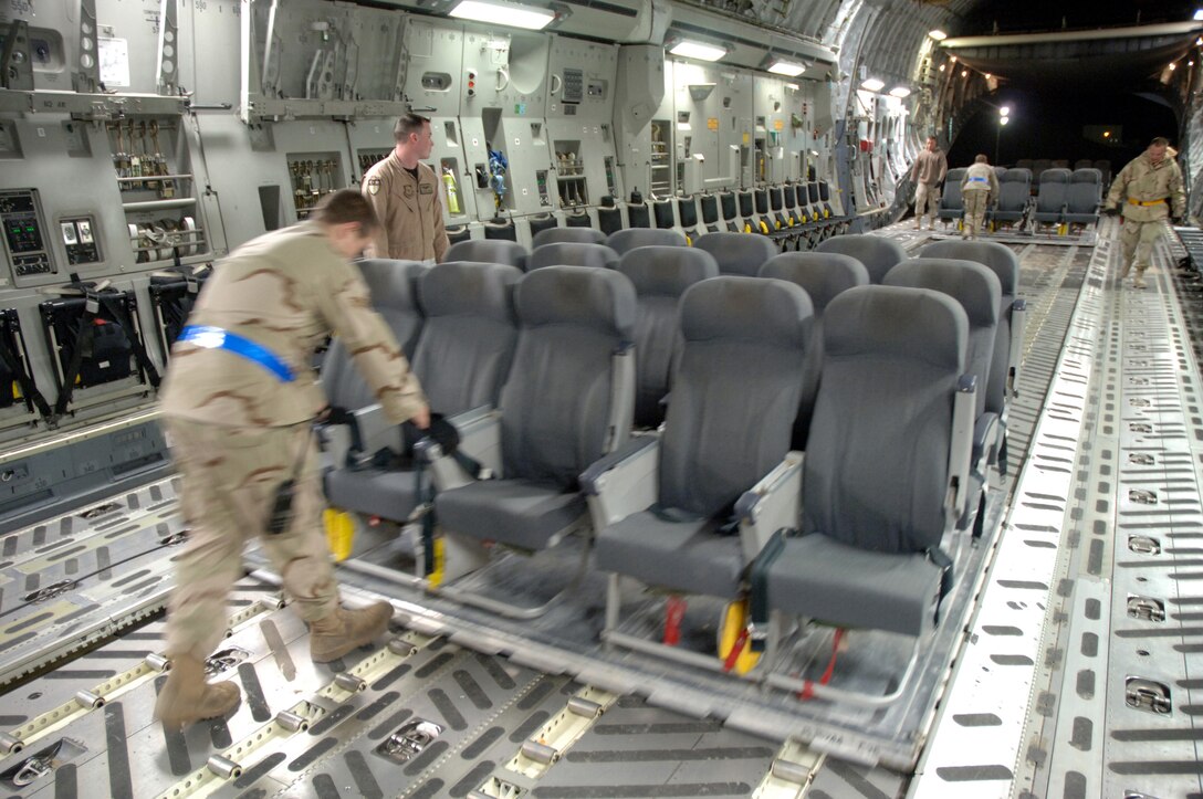 Crewmembers from the 817th Expeditionary Airlift Squadron unload pallets of troop seats from a C-17 Globemaster III at a deployed location in Southwest Asia on Sunday, Mar. 12, 2006. The aircraft is deployed from McChord Air Force Base, Wash. (U.S. Air Force photo/Staff Sgt. Joshua Strang) 