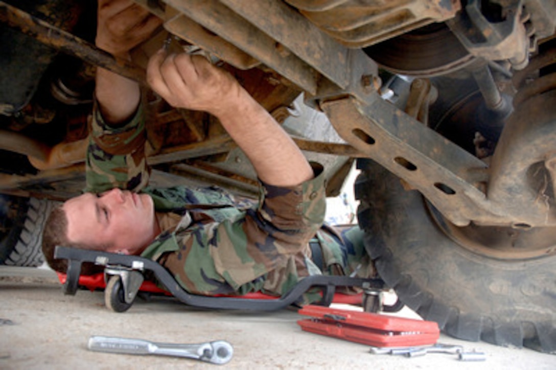 U.S. Navy Constructionman Sean Murphy reassembles a driveshaft after replacing the carrier bearing on a Humvee during a battalion field exercise at Naval Construction Battalion Center Gulfport, Miss., on March 9, 2006. Murphy, a Navy construction mechanic, is assigned to Naval Mobile Construction Battalion 1. 