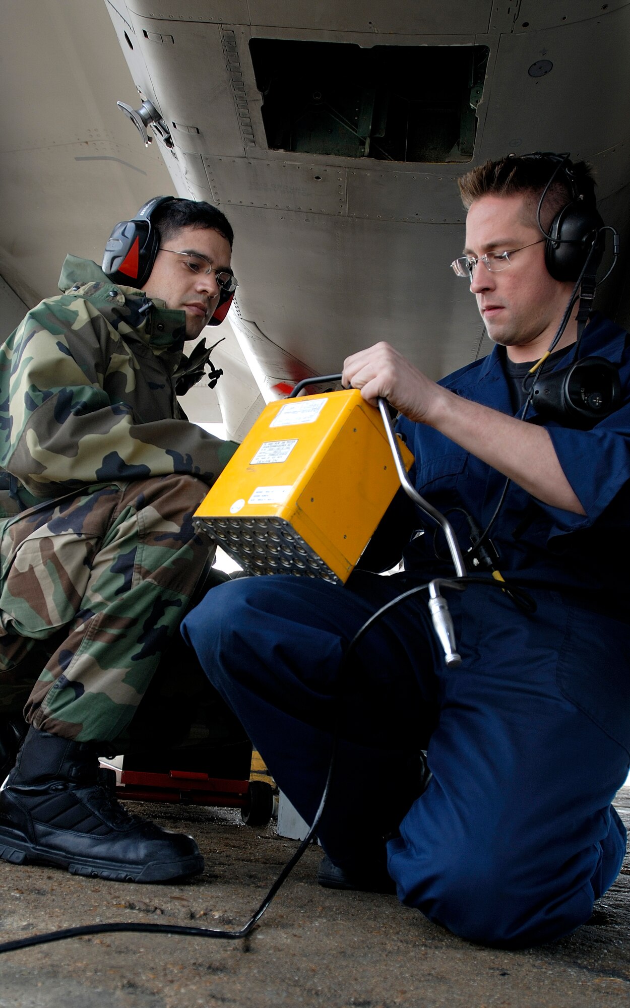 Staff Sgt. James Skonieczny and Senior Airman Ramses Garavito inspect an F-15 Eagle Tuesday, March 14, 2006, at Langley Air Force Base, Va.  Both Airmen are with the 71st Aircraft Maintenance Unit.  (U.S. Air Force photo/Airman First Class Christopher Ingersoll)

 
