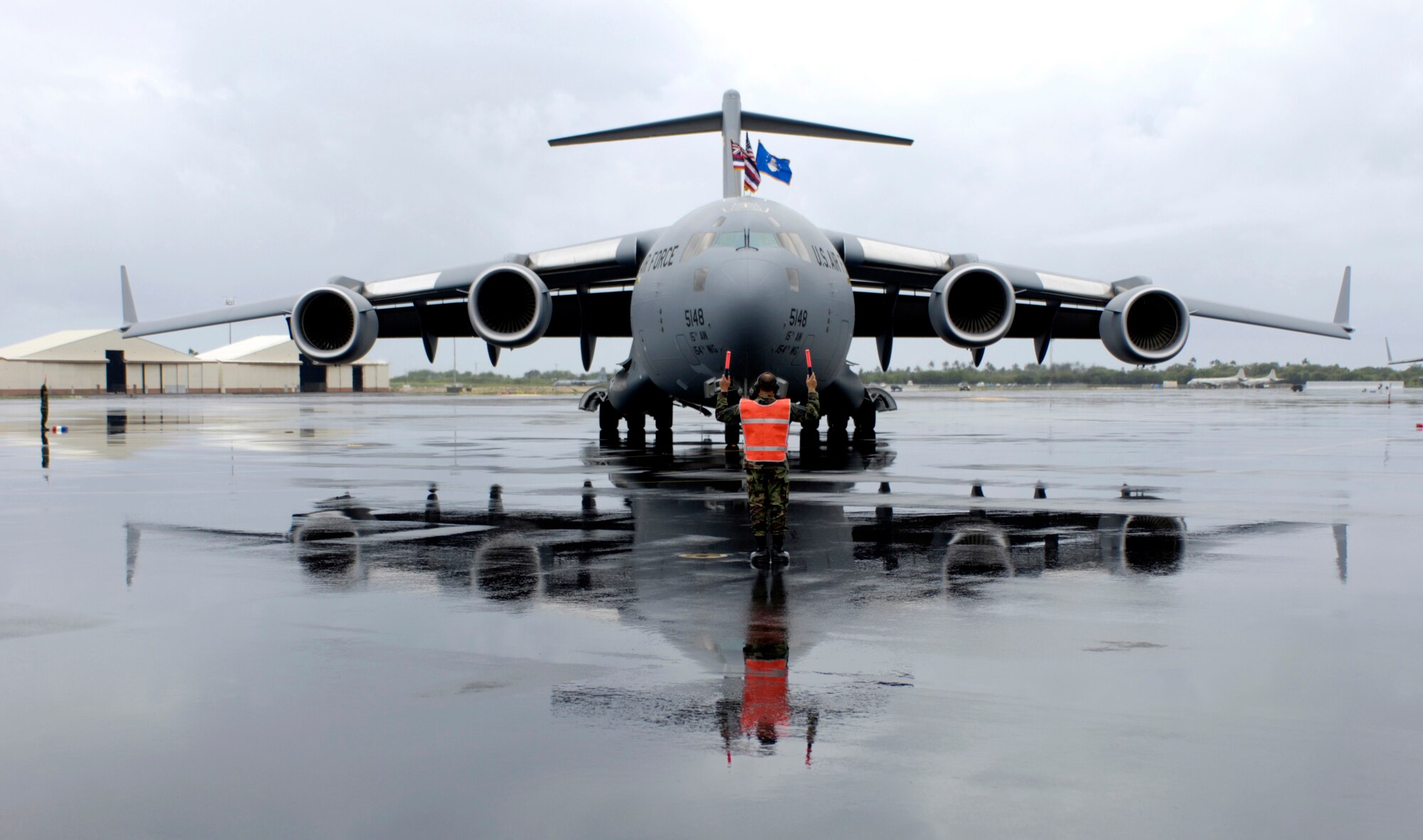 Master Sgt. Salvador Baltazar marshals in Hickam's third C-17 Globemaster III at Hickam Air Force Base, Hawaii, Tuesday, March 14, 2006. Hickam will be getting eight C-17s that will enhance military capabilities to rapidly deploy assets throughout the Pacific. Sergeant Baltazar is a Hawaii Air National Guard crew chief from the 154th Maintenance Squadron. (U.S. Air Force photo/Tech. Sgt. Shane A. Cuomo)