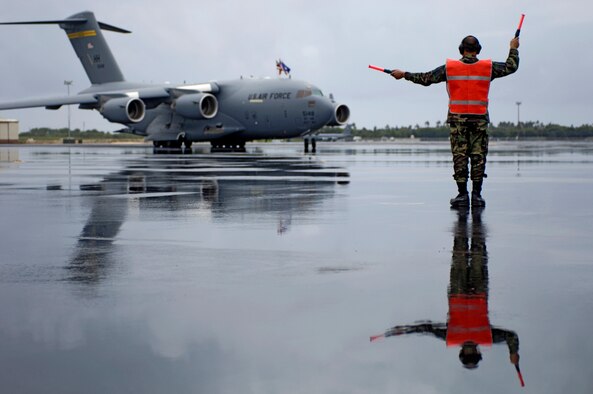 Master Sgt. Salvador Baltazar marshals in Hickam's third C-17 Globemaster III at Hickam Air Force Base, Hawaii, Tuesday, March 14, 2006. Hickam will be getting eight C-17s that will enhance military capabilities to rapidly deploy assets throughout the Pacific. Sergeant Baltazar is a Hawaii Air National Guard crew chief from the 154th Maintenance Squadron. (U.S. Air Force photo/Tech. Sgt. Shane A. Cuomo)