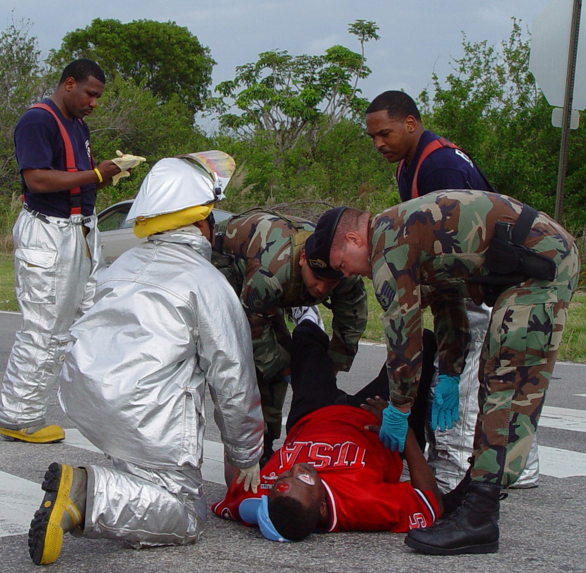 Firefighters and Security Forces Airmen from Homestead Air Reserve Base, Fla., care for Master Sgt. Frederick Dawson during a mass casualty exercise held here on March 14.  The exercise scenario involved a suicide car bombing near the main entrance to the base (U.S. Air Force Reserve photo by Lisa Macias). 