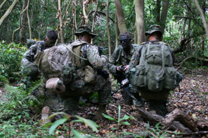 Marines with 3rd Platoon, Golf Company, Battalion Landing 2/5 take a rest in a jungle clearing during a weeklong patrolling training package at the beginning of the 15th MEU's scheduled deployment. ::r::::n::   Golf Company arrived in Hawaii about a week in advance of the main body of the 15th MEU to conduct sustainment training at Hawaii's numerous training ranges.      ::r::::n::   The Camp Pendleton, Calif. based 15th MEU is comprised of approximately 2,200 Marines and Sailors and is a forward deployed force of readiness capable of conducting numerous operations, such as Non-Combatant Evacuation Operations, Humanitarian Assistance Operations and a wide range of amphibious missions. The 15th MEU is currently deployed aboard the USS Peleliu (LHA-5), USS Dubuque (LPD-8) and USS Pearl Harbor (LSD-52). (Official USMC photo by Lance Cpl. Timothy T. Parish) (Released)::r::::n::