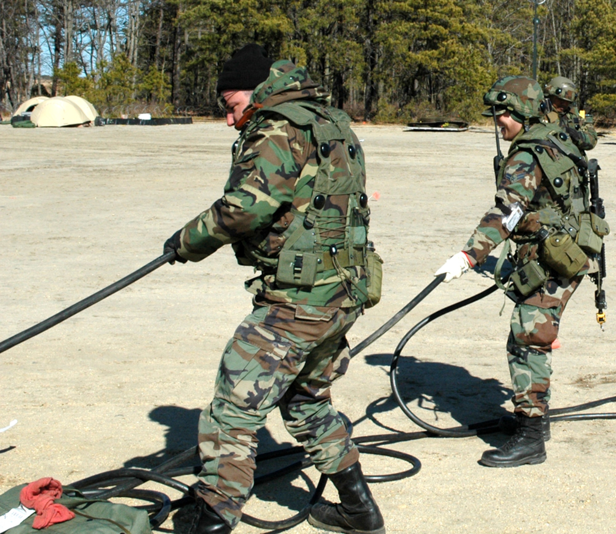 Staff Sgt. Daniel Ballard, 571st Global Mobility Squadron aerospace ground equipment technician and Airman 1st Class Bryan Quiboloy, 571st GMS aerial port mobility team member, connect power from a generator to a tent. (U.S. Air Force photo by 2nd Lt. Lindsey Hahn)