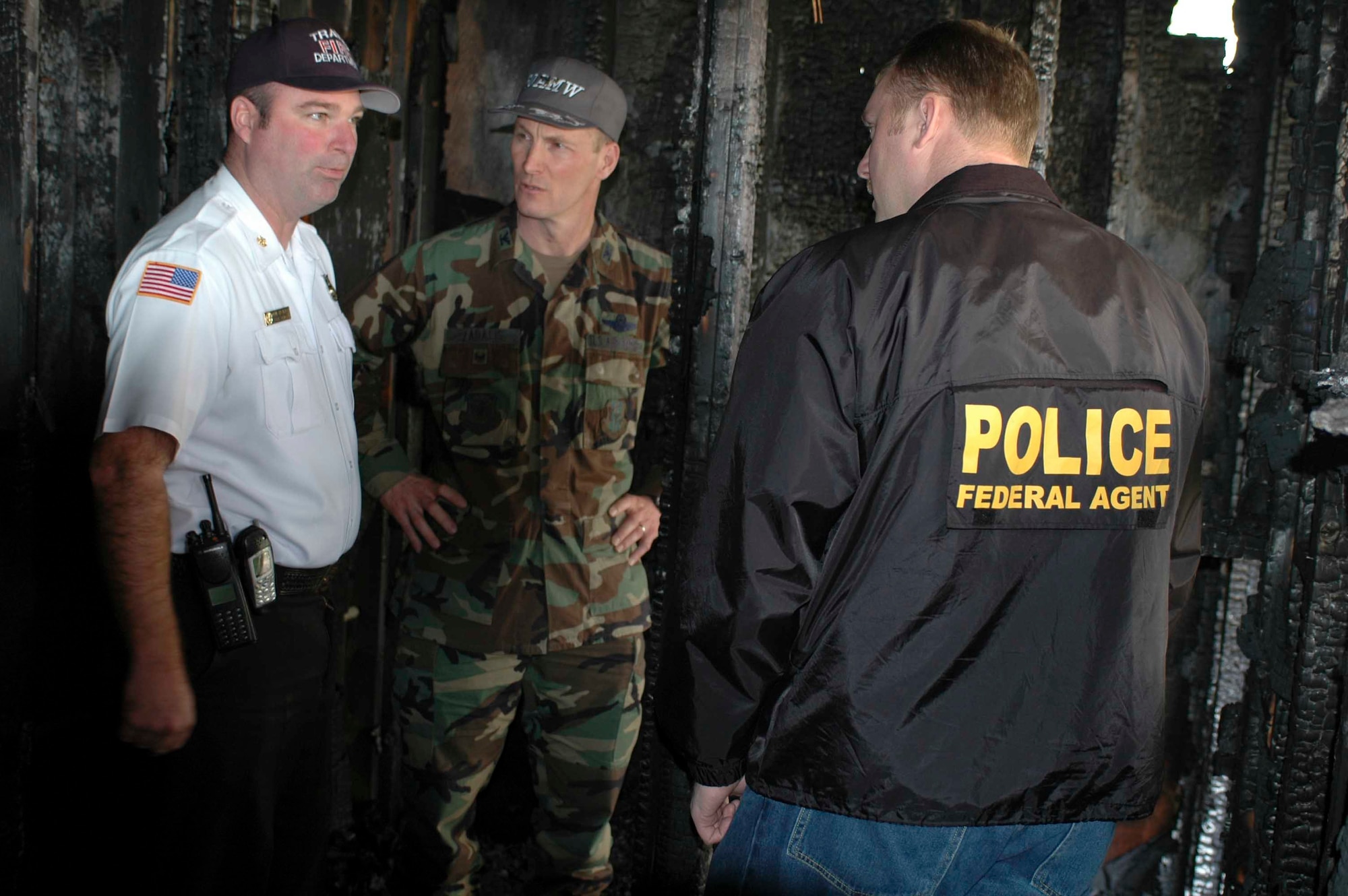 Mr. John Speakman, 60th Civil Engineer Squadron fire chief, Col. Timothy Zadalis, 60th Air Mobility Wing acting commander, and an Office of Special Investigations agent, review the result of an intentional fire in a bathroom at Eucalyptus Park. (U.S. Air Force photo by Staff Sgt. Matt McGovern)
   
