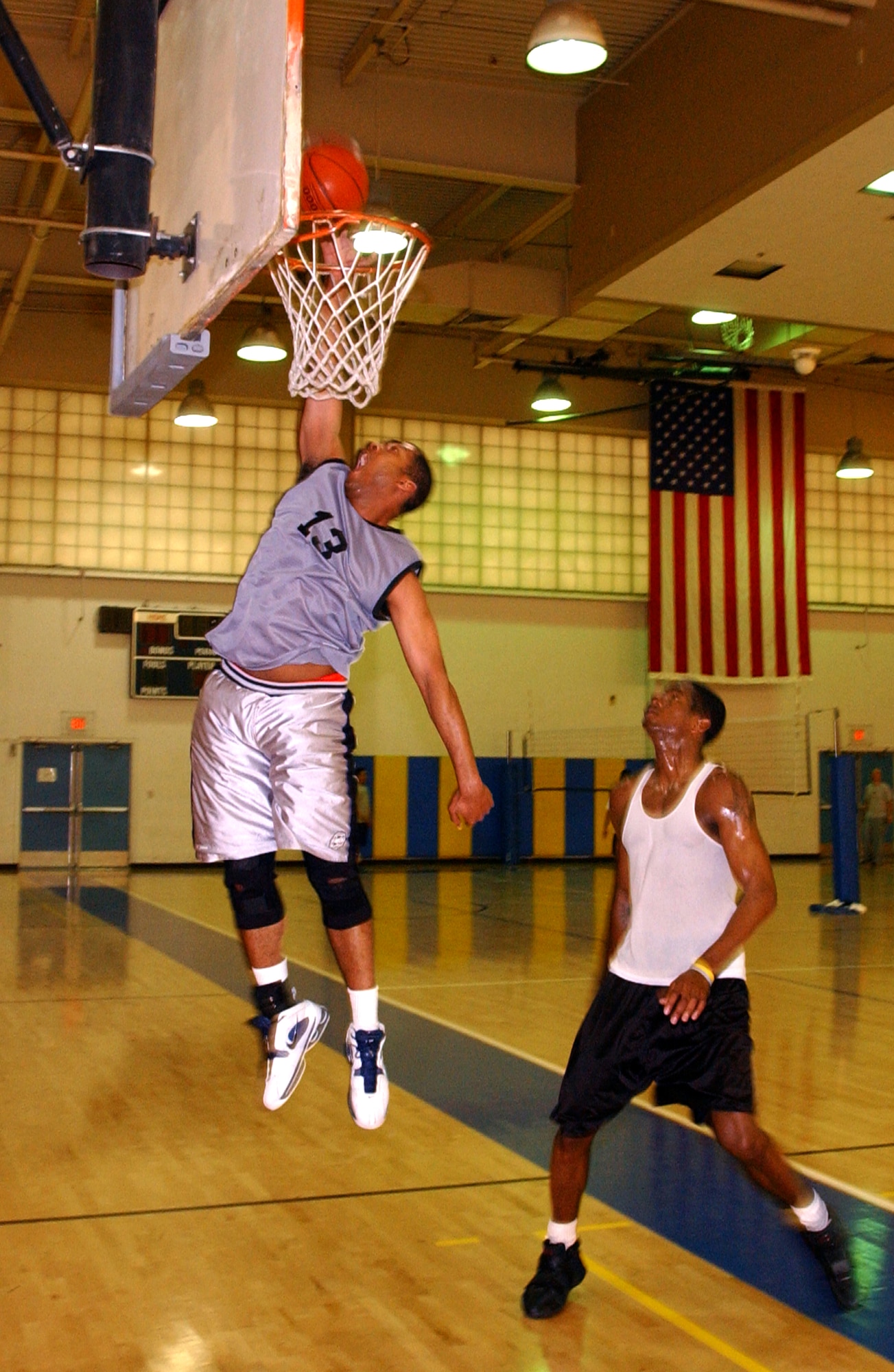 Johnny Cohnes, (left) 60th Medical Support Squadron, finishes strong at the hoop as Robert Gray, (right) 60th Component Maintenance Squadron, looks on. (U.S. Air Force photo by Nan Wylie)                 
