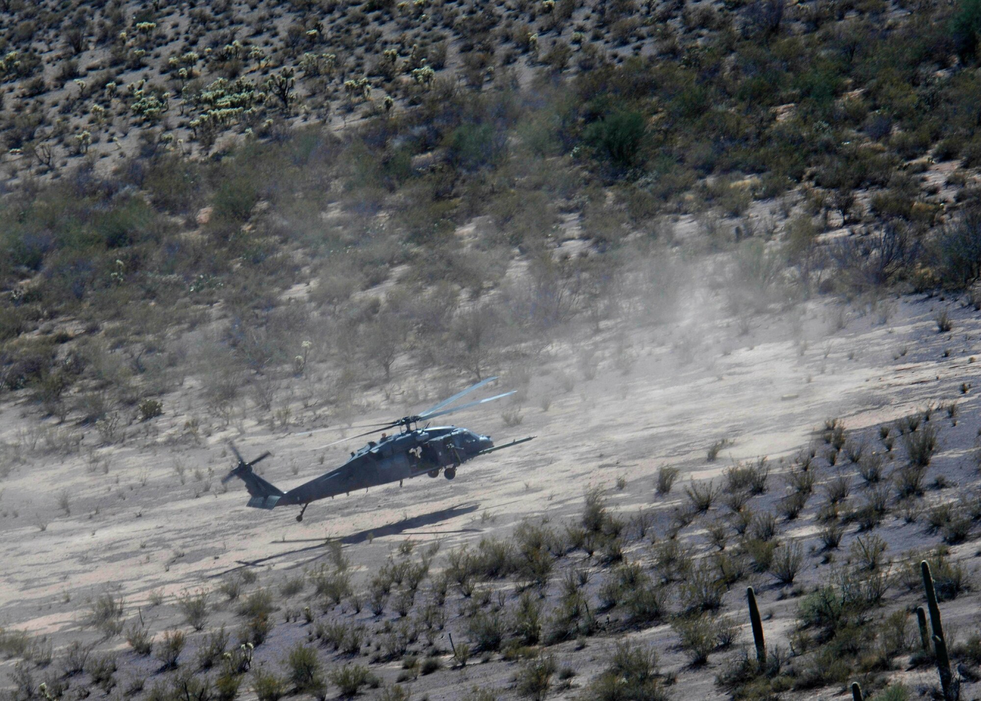 A HH-60 Pavehawk filled with pararescuemen from the 48th Rescue Squadron practice various types of training near Davis-Monthan Air Force Base, Ariz., Monday, March 13, 2006. Aircrews from the 55th Rescue Squadron and pararescuemen assigned to the 48th Rescue Squadron were conducting alternate insertion/extraction training. (U.S Air Force photo/Senior Airman Christina Ponte)