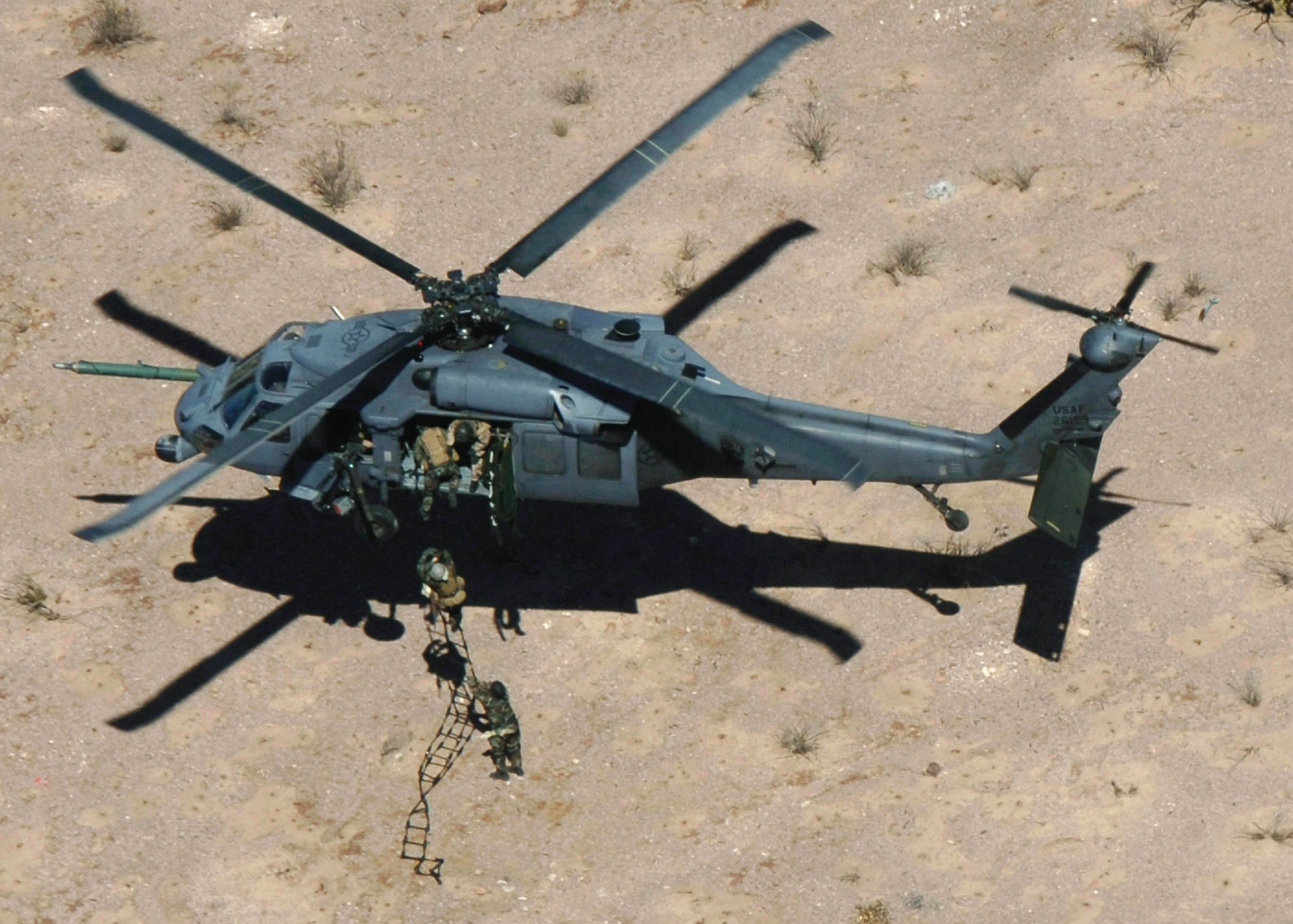 Pararescuemen from the 48th Rescue Squadron climb down a rope ladder, out of a HH-60 Pavehawk, as part of alternate insertion/extraction training, Monday, March 13, 2006. The 55th Rescue Squadron and pararescuemen assigned to the 48th Rescue Squadron were conducting alternate insertion/extraction training near Davis-Monthan Air Force Base, Ariz. (U.S Air Force photo/Senior Airman Christina Ponte)