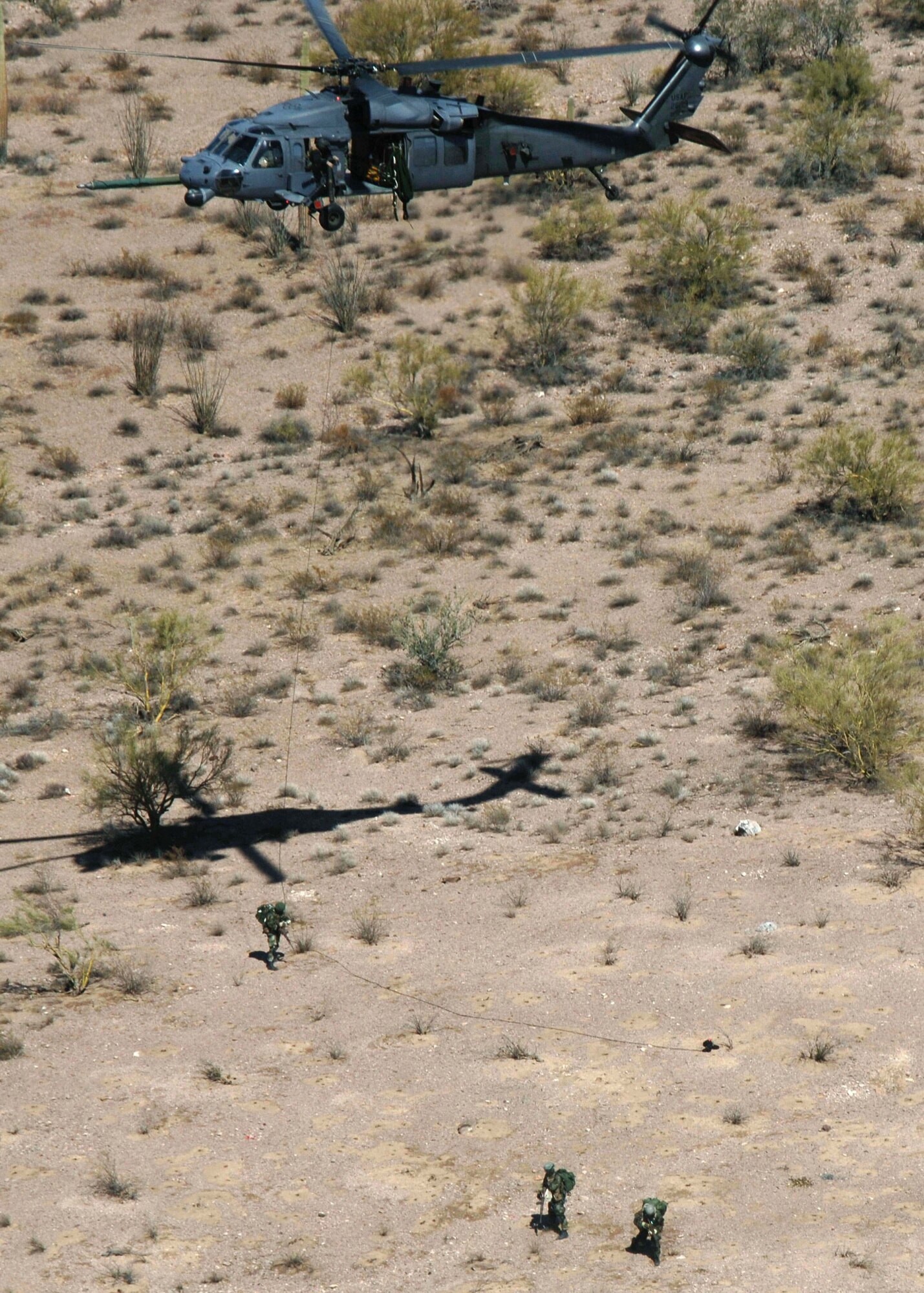 Pararescuemen from the 48th Rescue Squadron, repel down a HH-60 Pavehawk helicopter into a simulated hot zone, Monday, March 13, 2006. The 55th Rescue Squadron and pararescuemen assigned to the 48th Rescue Squadron were conducting alternate insertion/extraction training near Davis-Monthan Air Force Base, Ariz. (U.S Air Force photo/Senior Airman Christina D. Ponte) 