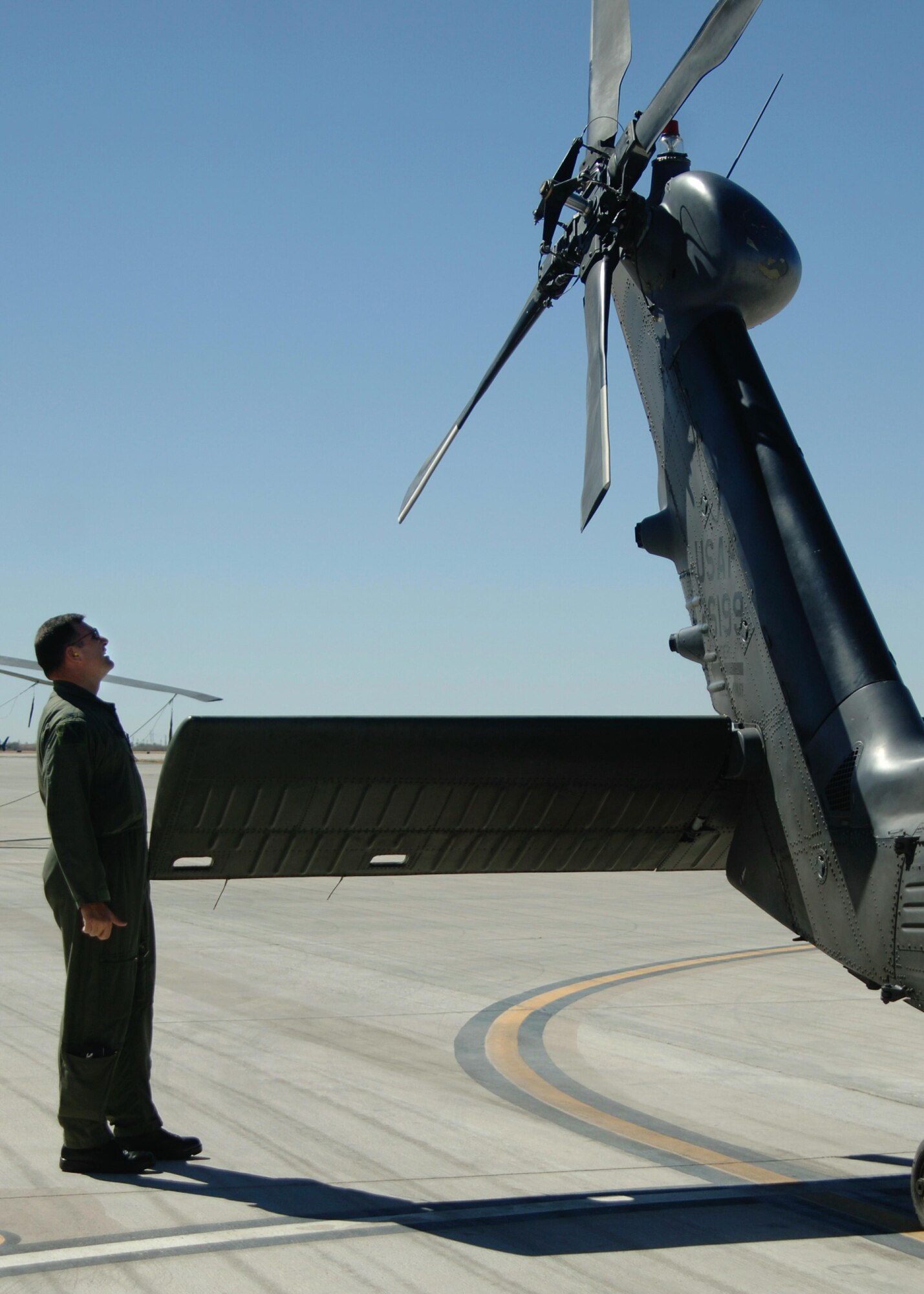 Col. Michael Korcheck performs pre-flight inspection checks before taking off in a HH-60 Pavehawk helicopter, Monday, March 13, 2006, at Davis-Monthan Air Force Base, Ariz. Colonel Korcheck flew with another HH-60 as training for the 55th Rescue Squadron and pararescuemen assigned to the 48th Rescue Squadron. Colonel Korcheck is the 563rd Rescue Group commander.  (U.S Air Force photo/Senior Airman Christina D. Ponte)