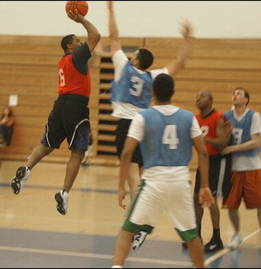 CANNON AIR FORCE BASE, N.M. -- MSS/CPTS’ Rich Mahaney tries to shoot over the outstretched arm of OG/OSS’ Adam Aviles to increase the score of his team’s 51-36 victory Monday. (U.S. Air Force photo by Airman Thomas Trower)