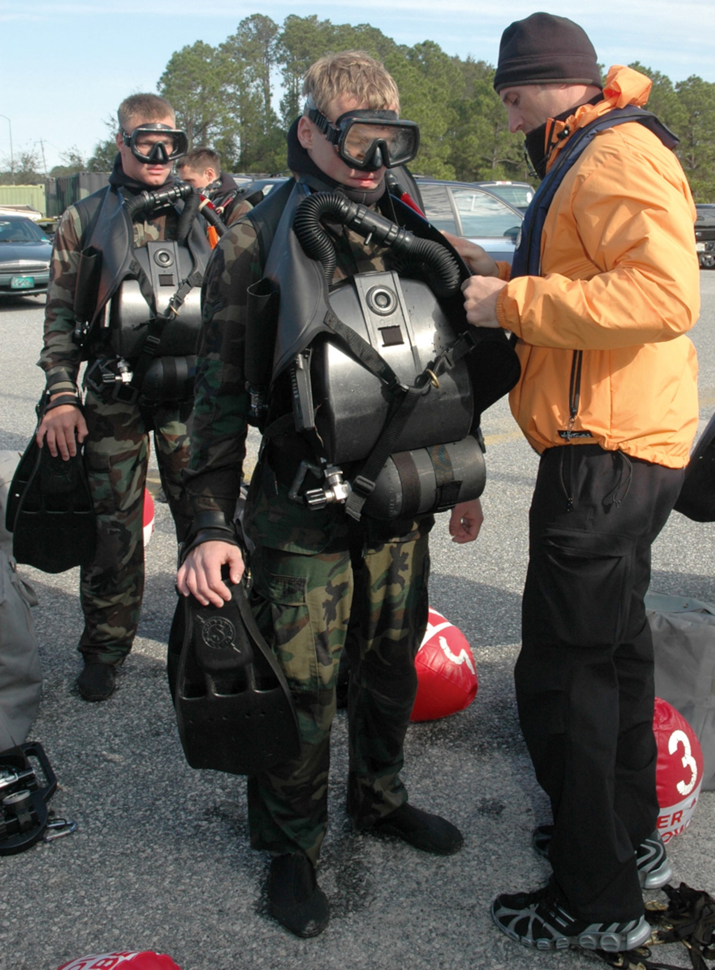 Tech. Sgt. Sean McGinley, instructor, inspects Airman 1st Class Conor Wesling, a Combat Dive Course pararescueman student. Instructors inspect each student before the students dive to ensure their equipment in connected correctly. (U.S. Air Force photo/Chrissy Cuttita) 