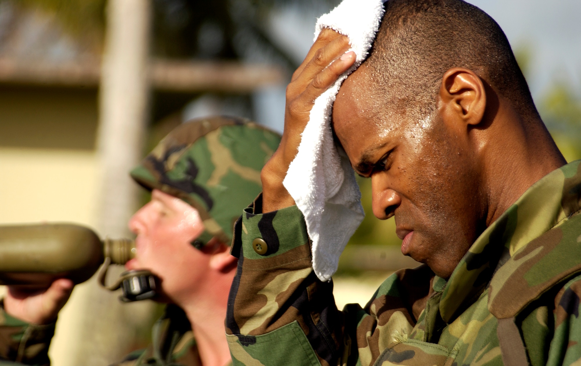 Capt. John Key wipes away the sweat running down his forehead during a break in convoy and weapons familiarization training, which is part of the Guam Initial Readiness Response Exercise, or GIRRE, Tuesday, March 14, 2006. The GIRRE is an annual island-wide exercise between Andersen Air Force Base and Naval Marianas to train on war plan deployments and joint disaster response skills. During the GIRRE, 300 Air Expeditionary Force Airmen will participate under conditions they may see when deployed. The mission of this exercise is readiness and to prepare AEF Airmen with skills they can use to keep alive downrange while working with Navy and Government of Guam agencies on disaster response to save lives at home. (U.S. Air Force photo/Airman 1st Class Miranda Moorer)