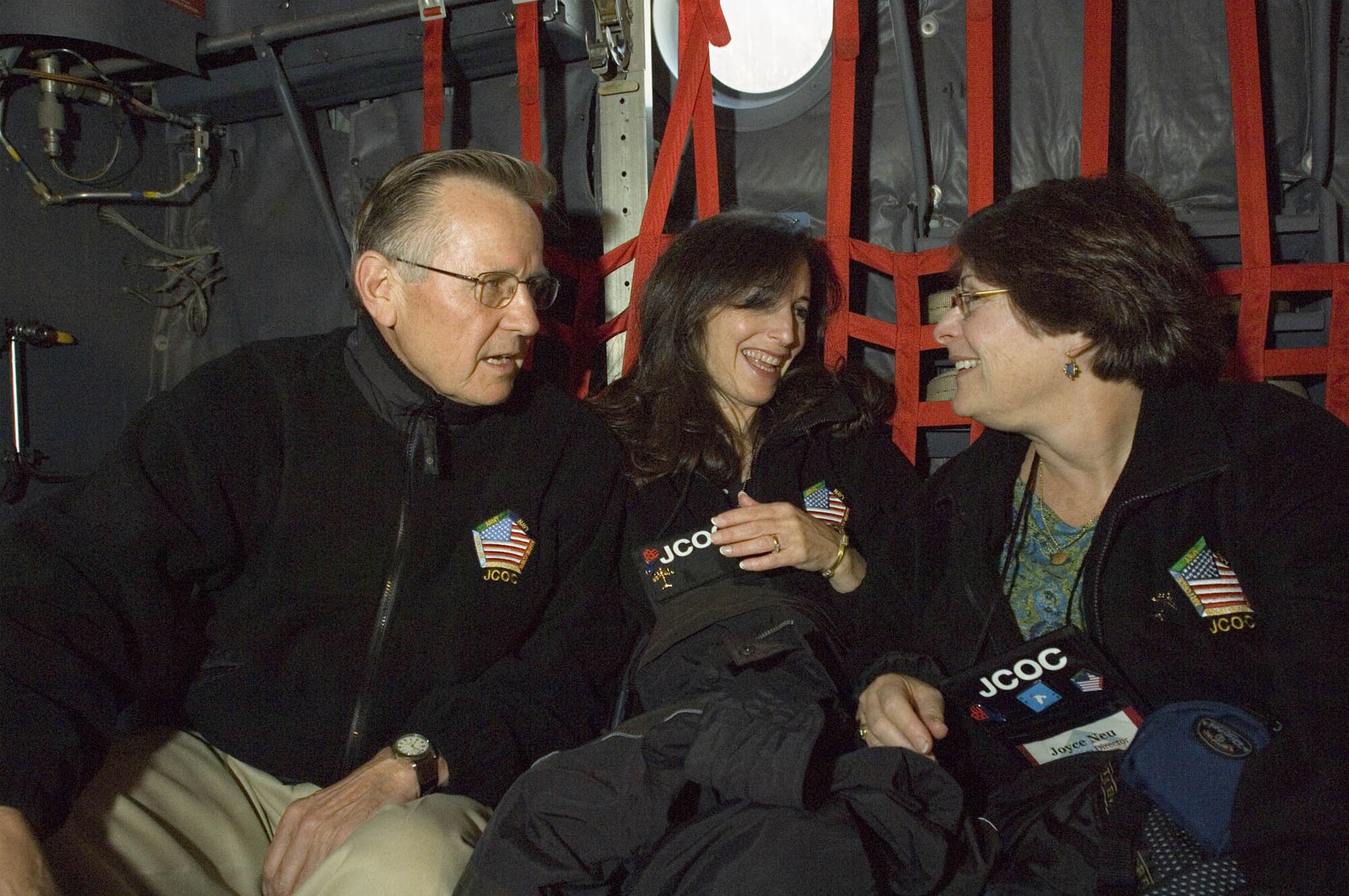 GRAFENWOER ARMY FIELD, Germany (USAFENS) -- Joint Civilian Orientation Conference participants (from left) Armon Mills, Elena Salsitz, and Dr. Joyce Neu enjoy conversation on the C-130 Hercules.  As part of the trip to Ramstein, the JCOC participants received an in-flight demonstration by the 86th Aeromedical Evacuation Squadron and a tour of the Landstuhl Regional Medical Center. (Photo by Master Sgt. John E. Lasky)