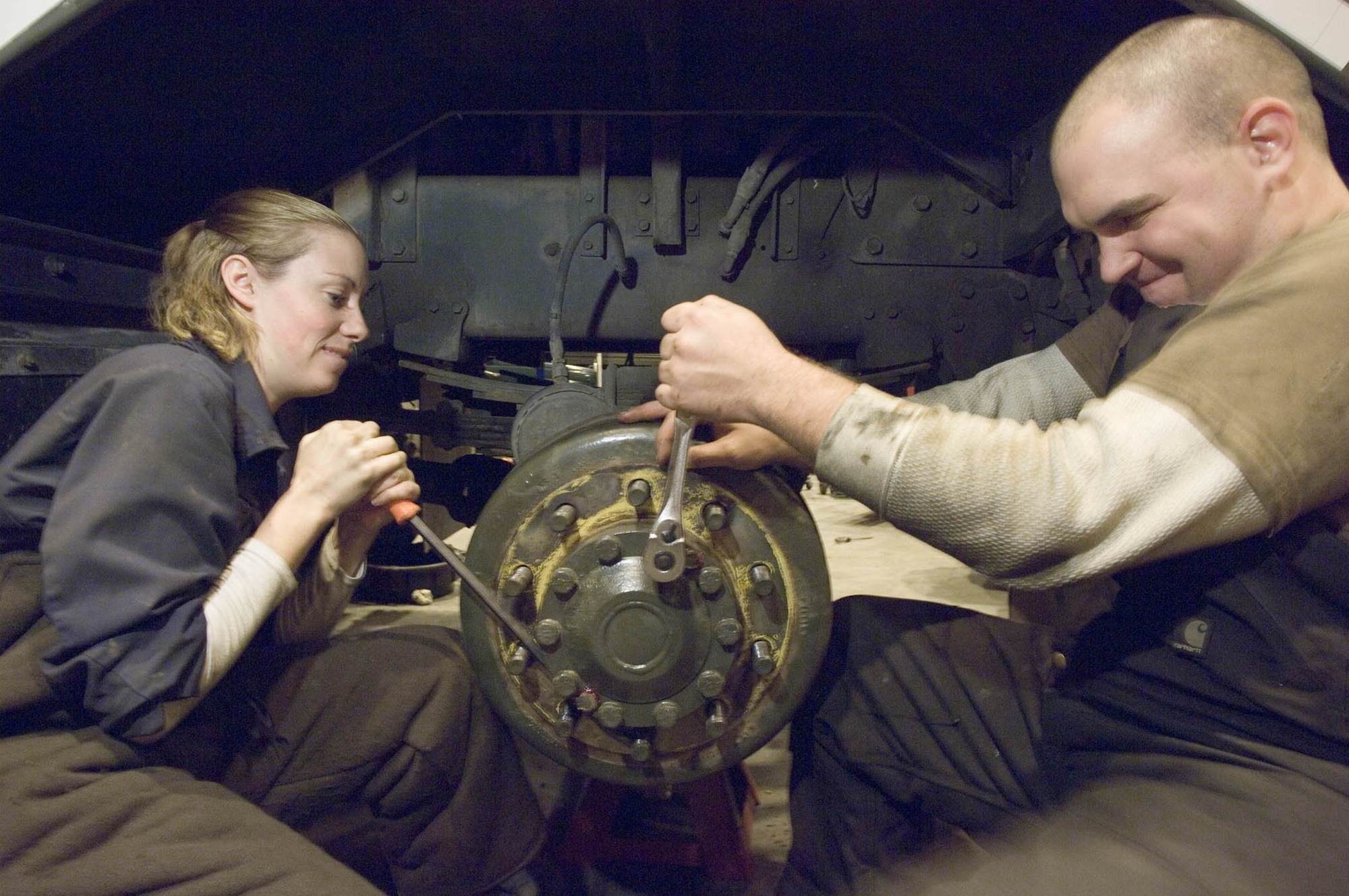 RAMSTEIN AIR BASE, Germany (USAFENS) – Senior Airman Heidi Pyper and Senior Airman Adam Simmons tighten the wheel hub cover on a snowblower at the 435th Vehicle Readiness Squadron’s Special Purpose Shop. Airmen Simmons and Pyper are vehicle and vehicular equipment maintainers working performing seasonal maintenance. Seventy one vehicles are receiving seasonal repairs such as dump trucks with plows, snow sweepers, de-icers, and snow blowers. (Photo by Master Sgt. John E. Lasky)