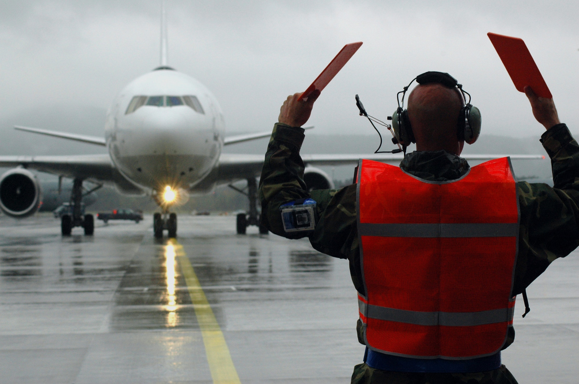 RAMSTEIN AIR BASE, Germany (USAFENS) -- Staff Sgt. Mike Hannahs, quality assurance branch chief inspector with the 723rd Air Mobility Squadron, marshals in the first Patriot Express aircraft here Oct. 1. The chartered air service was transferred to Ramstein as part of the Rhein-Main Transition Program. (Photo by Capt. Jonathan Friedman)