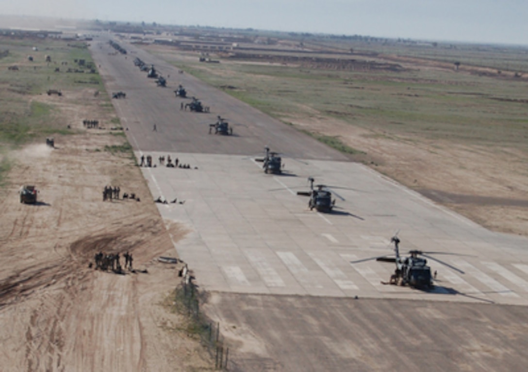 U.S. Army soldiers, Iraqi soldiers and U.S. aircraft are positioned on the airstrip at Forward Operating Base Remagen, Iraq, in preparation for Operation Swarmer on March 16, 2006. Operation Swarmer is a combined air assault operation to clear the area northeast of Samarra of suspected insurgents. The soldiers are from the Iraqi Army's 1st Brigade, 4th Division, and the U.S. Army's 101st Airborne Division's 3rd Brigade Combat Team, and the 101st Combat Aviation Brigade. 