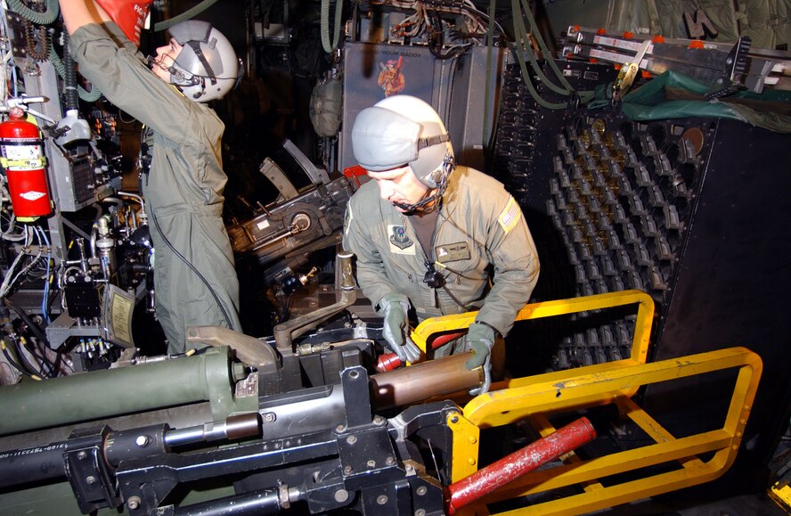 Aerial gunners from the 4th Special Operations Squadron, load a 105 mm Howitzer cannon aboard an AC-130U gunship.