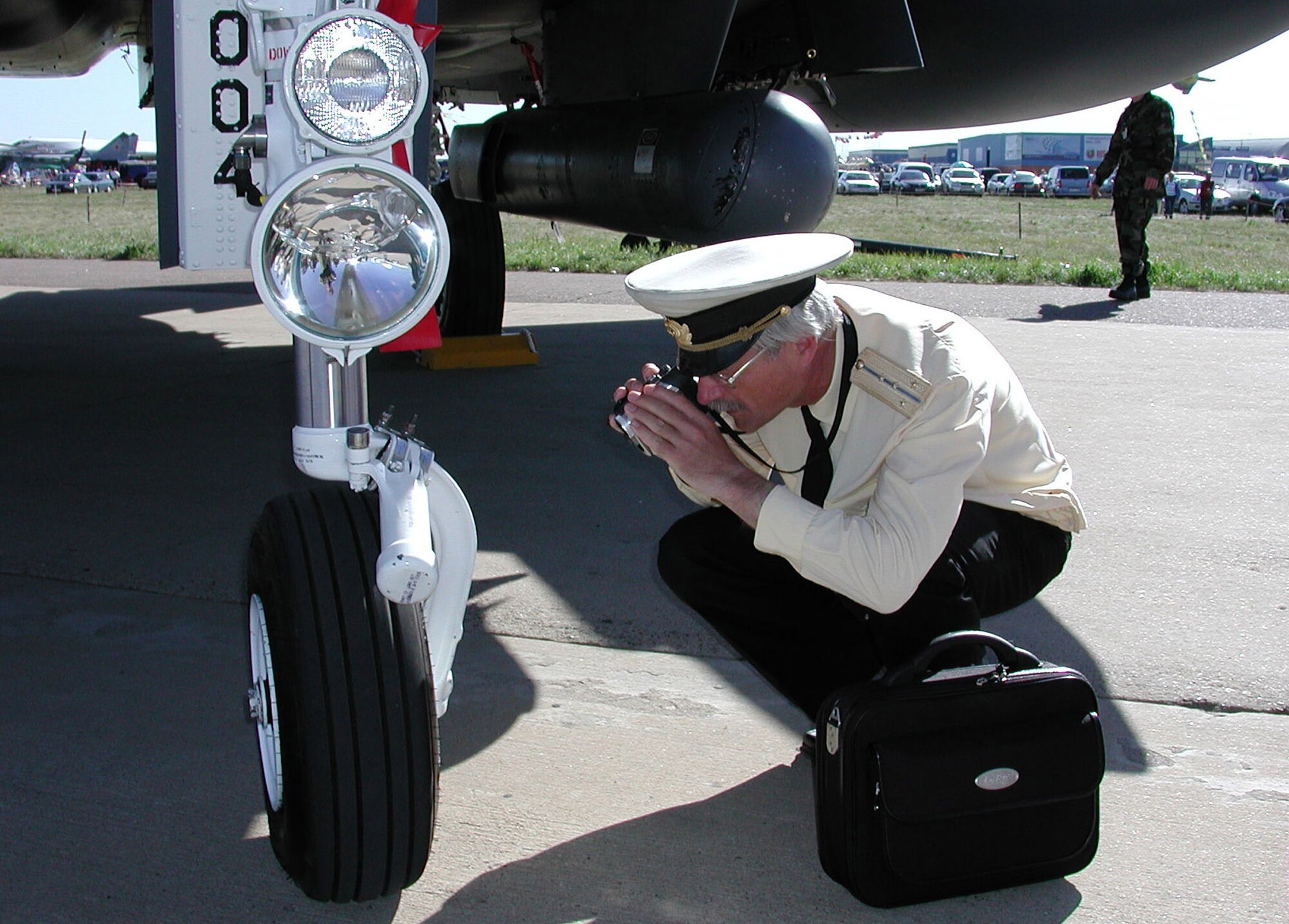 ZHUKOVSKY, Russia (USAFENS) -- Alexander Titov, a retired Russian air force engineer, closely examines the landing gear of an F-15E from RAF Lakenheath, England Aug. 18 at the Moscow International Air Show and Space Salon at Ramenskoye Airfield here. The plane was part of an international display of fighters set up for the mayor of Moscow. (Photo by 1st Lt. Tracy Page)