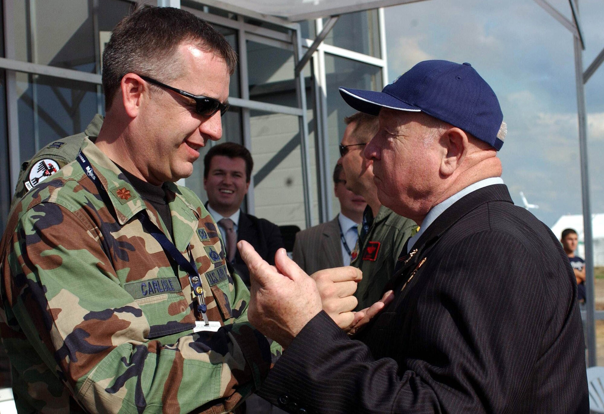 ZHUKOVSKY, Russia (USAFENS) -- Maj. Matt Carlisle, U.S. Air Forces in Europe deputy branch chief of international relations Eurasia branch, places a U.S. Air Force pin on two-time hero retired Russian Cosmonaut Alexi Leonov Aug. 16 at the Moscow International Air Show and Space Salon at Ramenskoye Airfield here Aug. 17. Approximately 100 U.S. military members and eight U.S. aircraft are playing an active part in the show Aug. 16-21. (Photo by Master Sgt. Mona Ferrell)