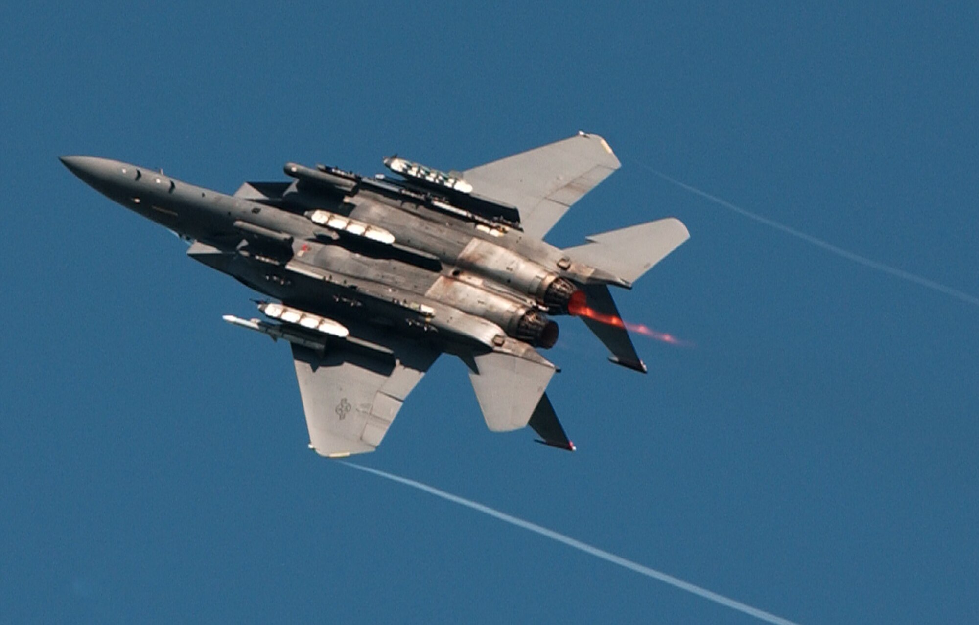ROYAL AIR FORCE HOLBEACH, England (USAFENS) -- An F-15E Strike Eagle from the 494thFighter Squadron, 48th Fighter Wing, RAF Lakenheath, United Kingdom, banks hard after shooting a strafing target at the bombing range here for the Excalibur exercise Aug. 16.  The Excalibur bombing competition was established to foster friendly relations between U.S. Air Forces in Europe and NATO, to increase esprit-de-corps between the respective pilots and to show basic visual bombing skills. (Photo by Airman 1st Class Jessica Struble)