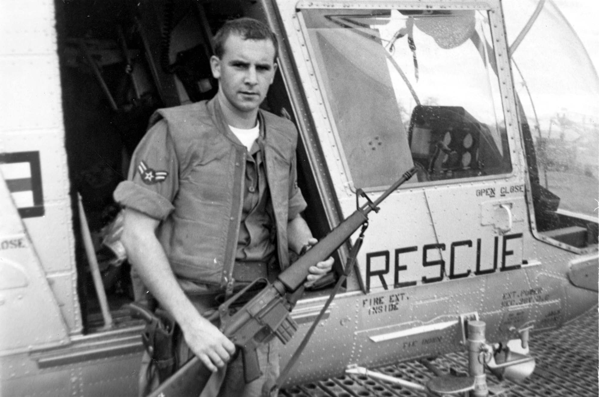 A1C William Pitsenbarger with an M-16 outside the HH-43. (U.S. Air Force photo)