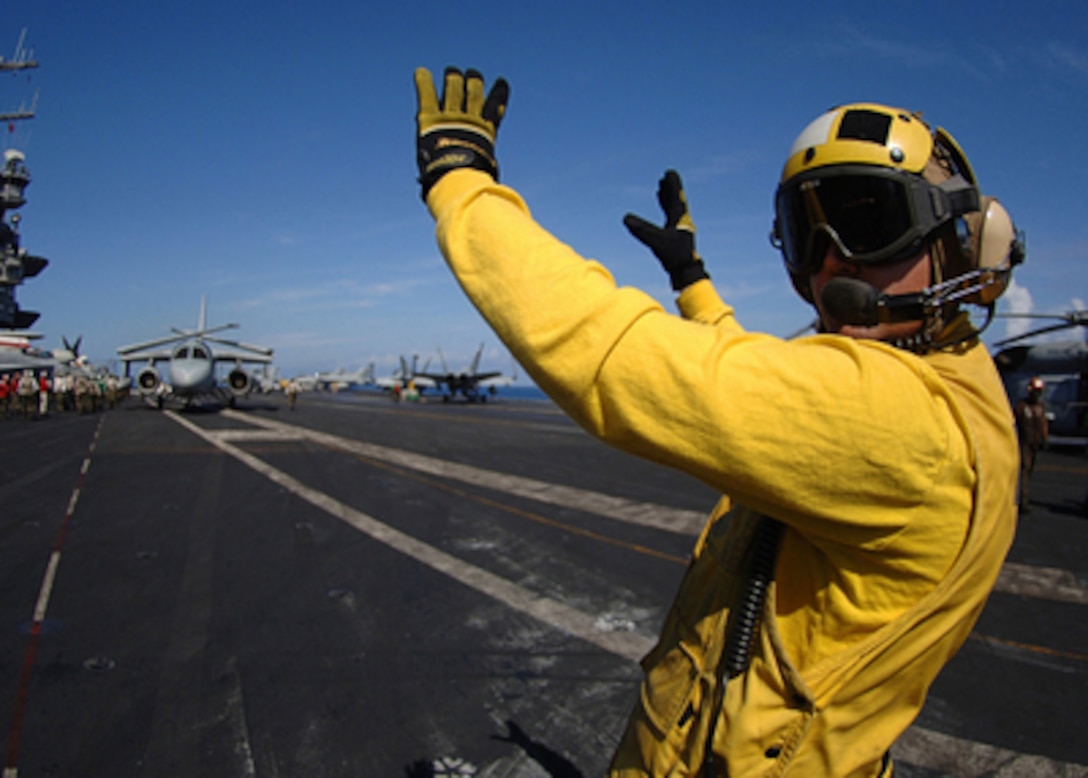 A U.S. Navy aviation boatswain's mate checks behind him as he directs an S-3B Viking aircraft to a catapult prior to launch from the flight deck of the aircraft carrier USS Enterprise (CVN 65) while the ship conducts flight operations in the Atlantic Ocean on March 13, 2006. Enterprise and its embarked Carrier Air Wing 1 are conducting a composite training unit exercise in the Atlantic. 