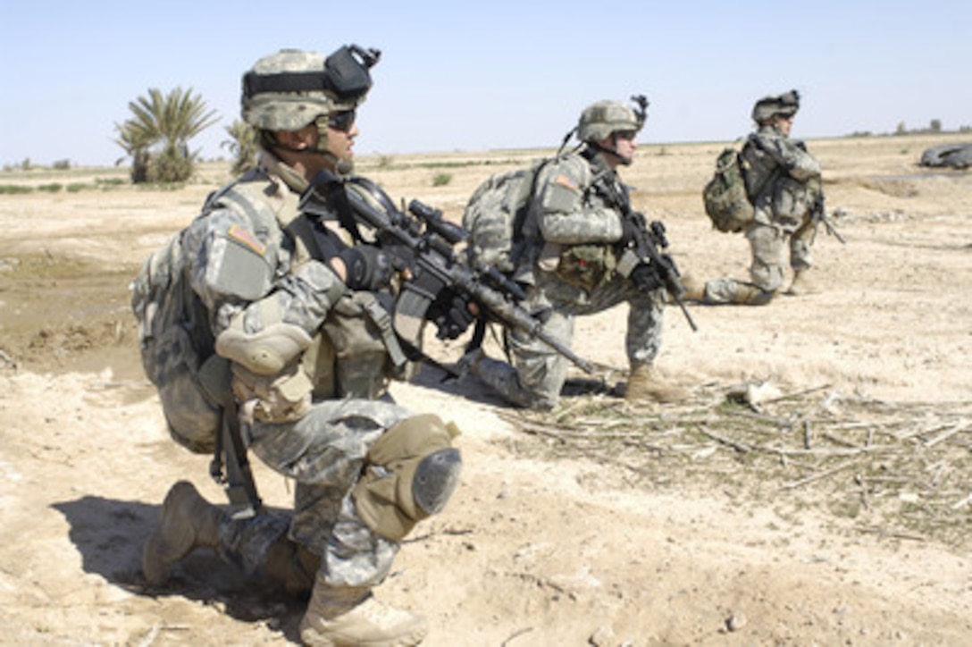 U.S. Army soldiers take a break as they advance through a field during Operation Swarmer in the Salah Ad Din province of Iraq on March 16, 2006. Operation Swarmer is a combined air assault operation to clear the area northeast of Samarra of suspected insurgents. The soldiers are from the Armyís 3rd Battalion, 187th Infantry Regiment. 
