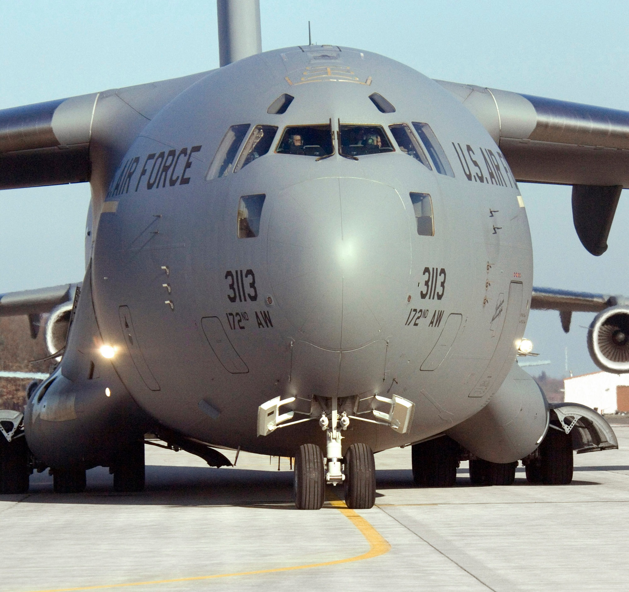 An Airman marshals a C-17 Globemaster III as it begins a mission from Ramstein Air Base, Germany, on Sunday, March 19, 2006. The Mississippi Air National Guard transport delivered cargo to Al Asad, Iraq, and returned from Balad Air Base, Iraq, as an aeromedical mission which put the air transport past the 1 millionth hour of flight time. (U.S. Air Force photo/Master Sgt. John E. Lasky) 