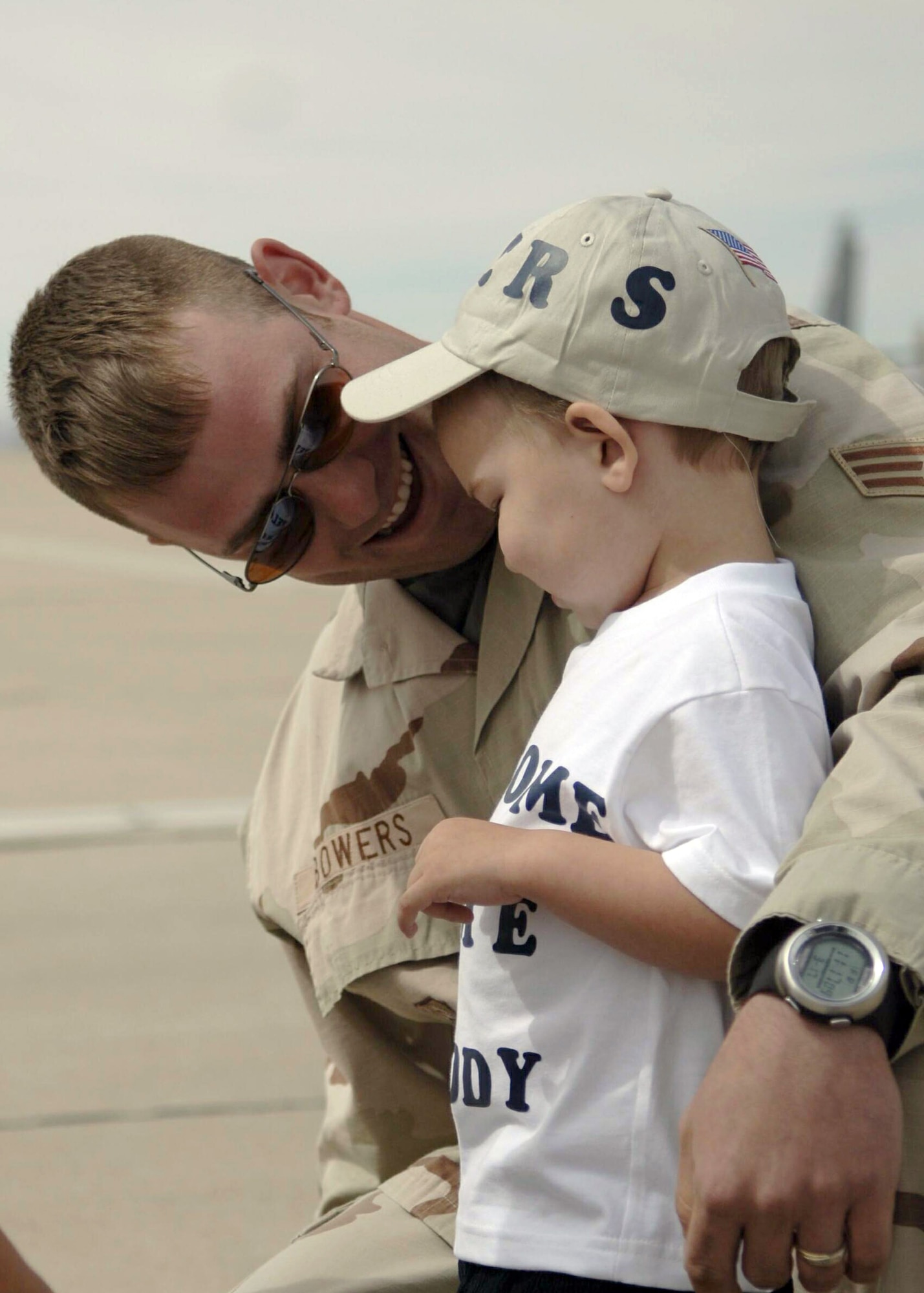 Senior Airman Jeffrey Bowers reunites with his son as he returns to Davis-Monthan Air Force Base, Ariz., Friday, March 17, 2006. The 355th Security Forces Squadron was deployed to Camp Bucca, Iraq, for nine months in support of Operation Iraqi Freedom. (U.S. Air Force photo/Senior Airman Christina Ponte)