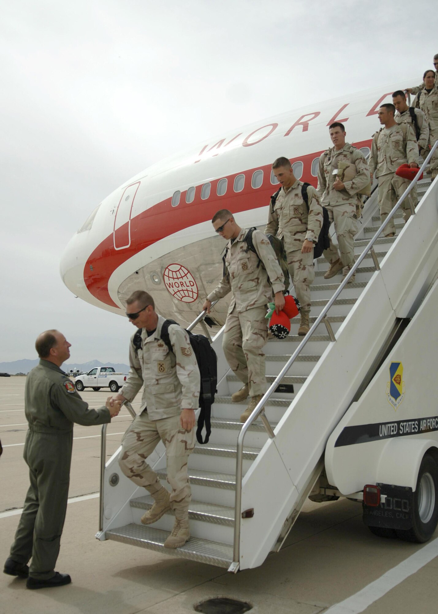 Airmen from the 355th Security Forces Squadron are welcomed by Col. Michael Spencer as they return from deployment to Davis-Monthan Air Force Base, Ariz., Friday, March 17, 2006. The squadron was deployed to Camp Bucca, Iraq, for nine months in Support of Operation Iraqi Freedom. Colonel Spencer is the 355th Wing Commander. (U.S. Air Force photo/Senior Airman Christina Ponte)