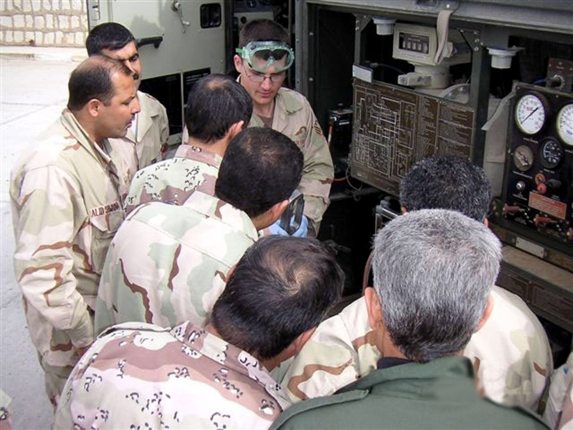 Senior Airman Keith Handley instructs members of the Iraqi Air Force on the procedures for testing aviation fuel at Kirkuk Air Base, Iraq. Airman Handley is with the 506th Expeditionary Logistics Readiness Squadron fuels flight. (Courtesy photo)

