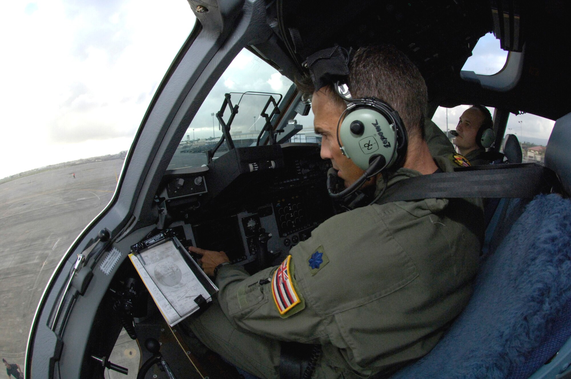 Lt. Col. Woody Woodrow and Maj. Matt Zehr conduct preflight checks on their C-17 Globemaster III Thursday, March 16, 2006, at Hickam Air Force Base, Hawaii. The C-17 delivered recovery equipment to the island of Kauai, Hawaii, after a dam burst, isolating thousands of people along the island's north shore. Colonel Woodrow is with the Hawaii Air National Guard's 204th Airlift Squadron and Major Zehr is with the 535th Airlift Squadron. (U.S. Air Force photo/Tech. Sgt. Shane A. Cuomo) 