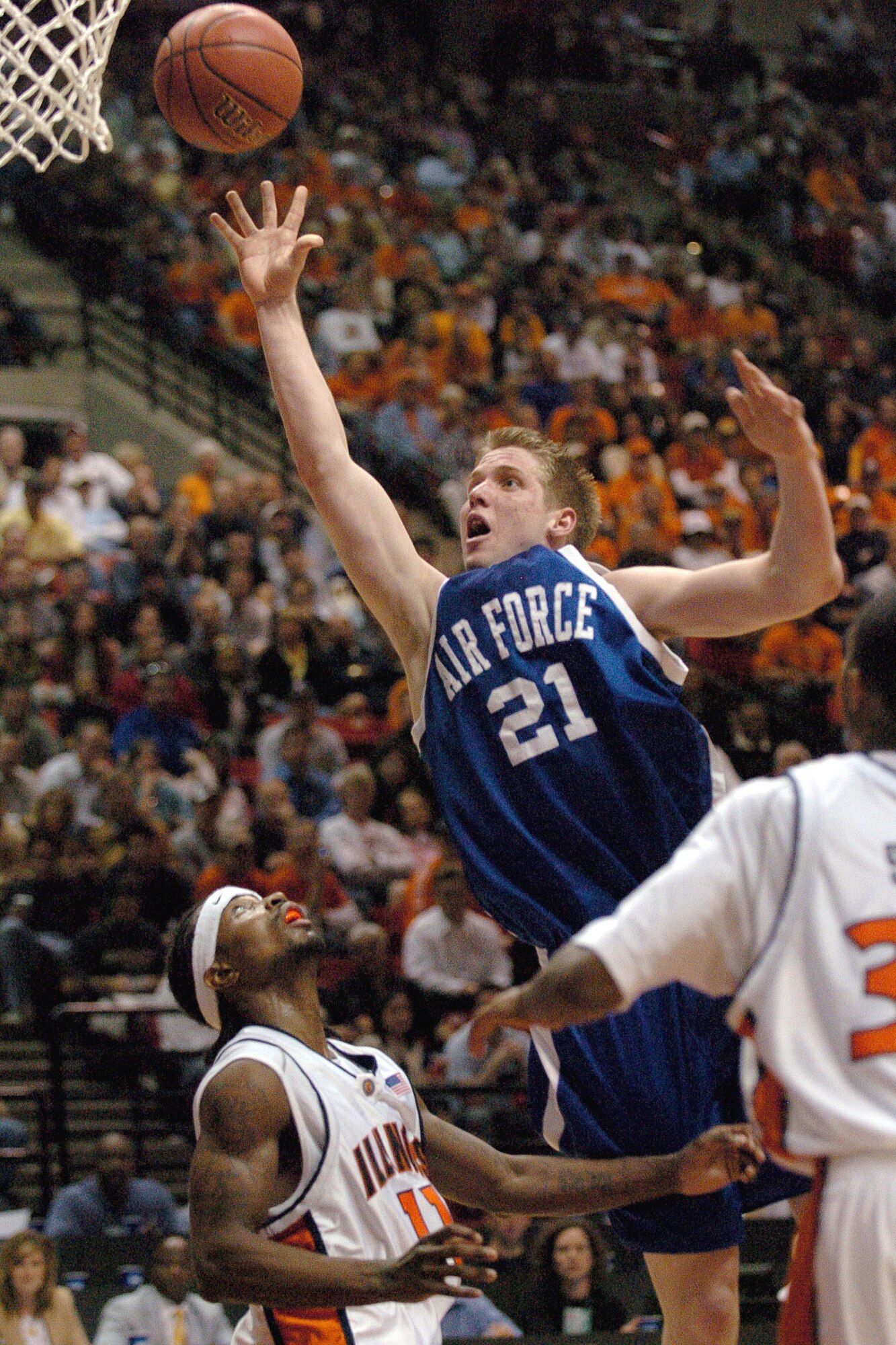 Falcon forward Jacob Burtschi flies to the basket above Illinois guard Dee Brown during the NCAA Tournament game Thursday, March 16, 2006, at Cox Arena in San Diego. (U.S. Air Force photo/Danny Meyer) 