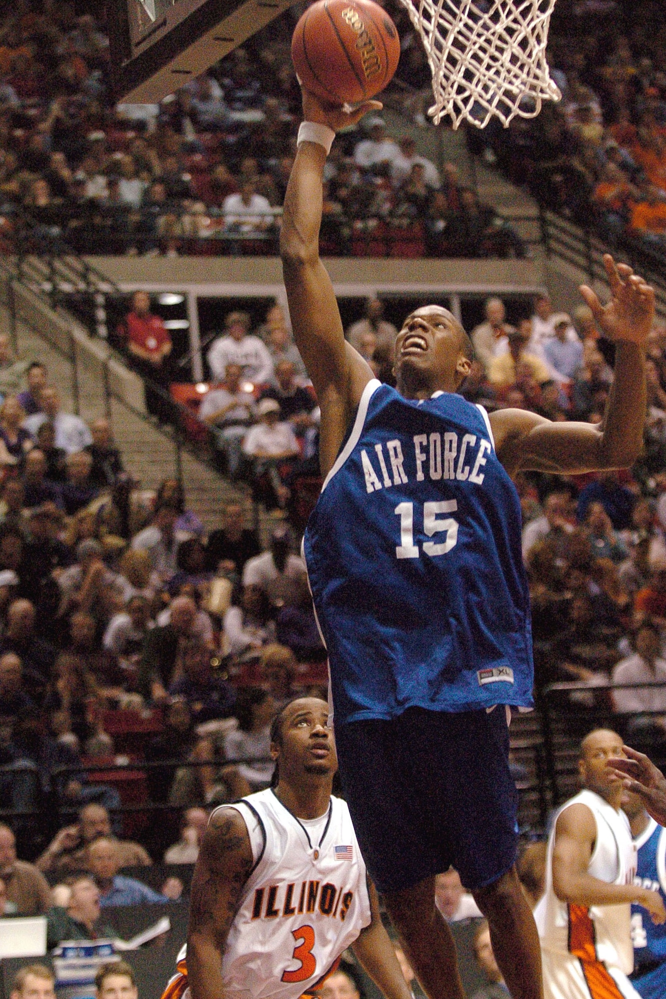 Falcon guard Antoine Hood goes strong to the basket above Illinois guard Chester Frazier, 3, during the NCAA Tournament game Thursday, March 16, 2006, at Cox Arena in San Diego. (U.S. Air Force photo/Danny Meyer) 

