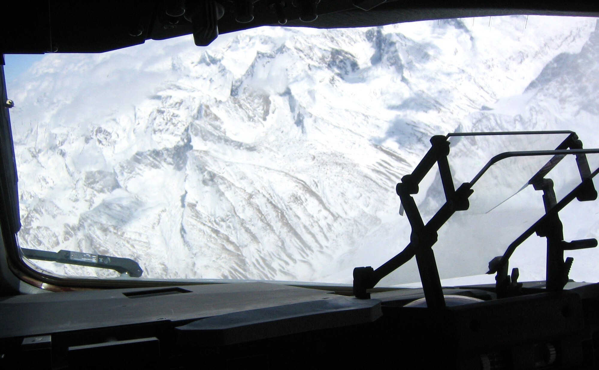 The snow-covered mountains of Afghanistan are seen from the cockpit of an Air Force C-17 Globemaster III. The humanitarian aid airdropped in the region help Afghans make it through the harsh winter months. The C-17 and accompanying aircrew are deployed to the 379th Air Expeditionary Wing at a forward-deployed location from McChord Air Force Base, Wash. (U.S. Air Force photo/Maj. Gabriel Greiss)