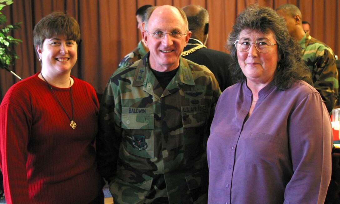 Caroline Blake (right), 422nd Air Base Group chaplain's assistant, and Brenda Nonnweiler, Catholic Religious Education and Parish coordinator, meet Chaplain (Maj. Gen.) Charles Baldwin, Air Force chief of chaplains, after the National Prayer Luncheon on March 6.
