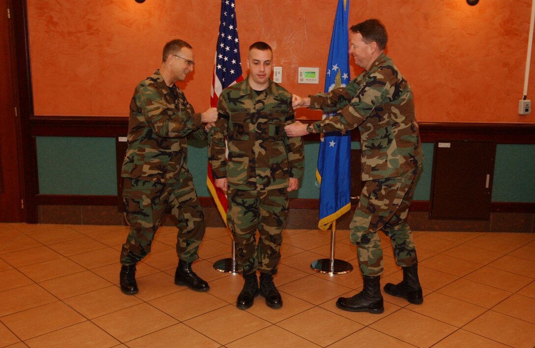 An Aviano Airman gets promoted by Col. Steven Schrader, 31st FW vice commander, during the monthly promotion ceremony at the La Bella Vista Club Feb. 28. Photo by Staff Sgt. Michael Holzworth