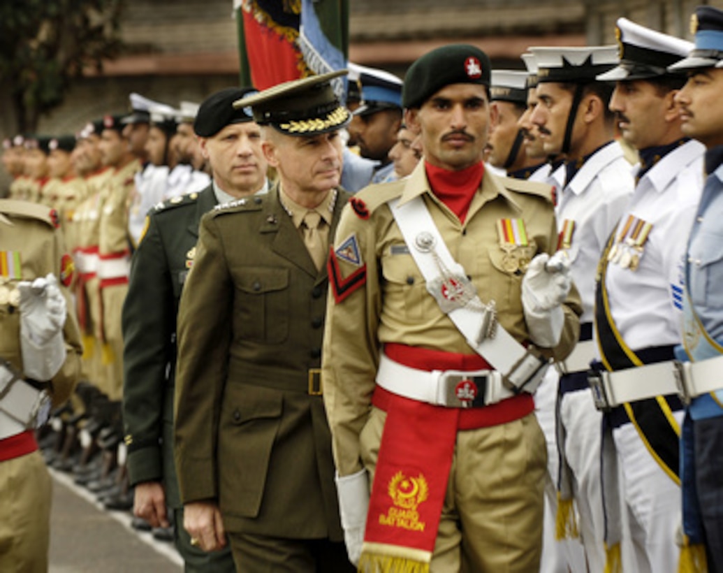 Chairman of the Joint Chiefs of Staff Gen. Peter Pace (center), U.S. Marine Corps, reviews the Pakistani Honor Guard upon his arrival at the Joint Forces Command in Islamabad, Pakistan, on March 20, 2006. Pace is in Islamabad to meet with his Pakistani counterpart Gen. Ehsan Ul Haq. Pace will later visit with American servicemembers who deployed to Pakistan for humanitarian relief efforts following the October 2005 earthquake near Muzaffarabad that killed an estimated 75,000 Pakistanis. 