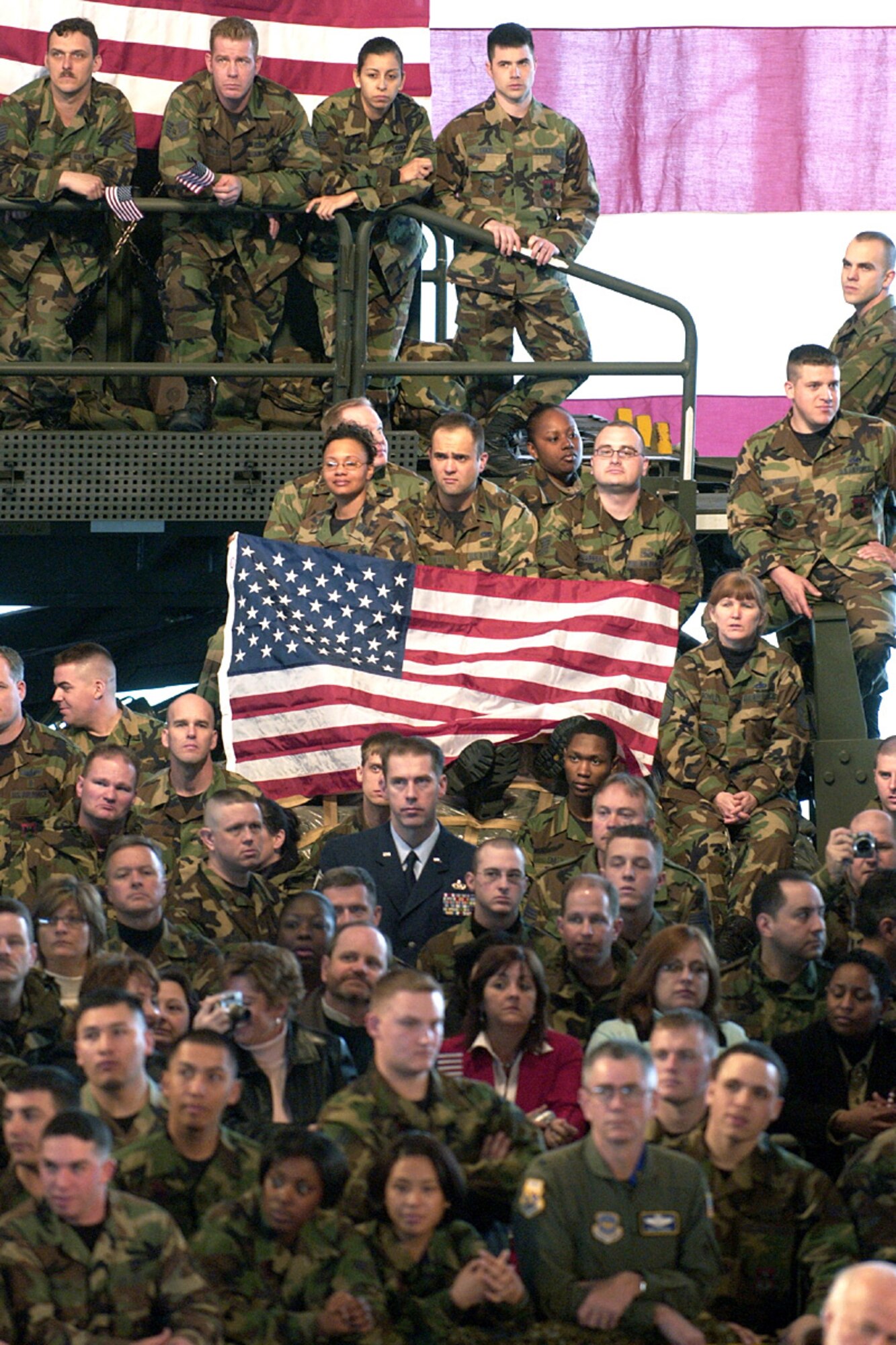Members of the Scott community cheer and wave the flag as Vice President Dick Cheney rallies the troops Tuesday, March 21, 2006, during his visit to Scott Air Force Base, Ill.  (U.S. Air Force photo/Marvin Lynchard)