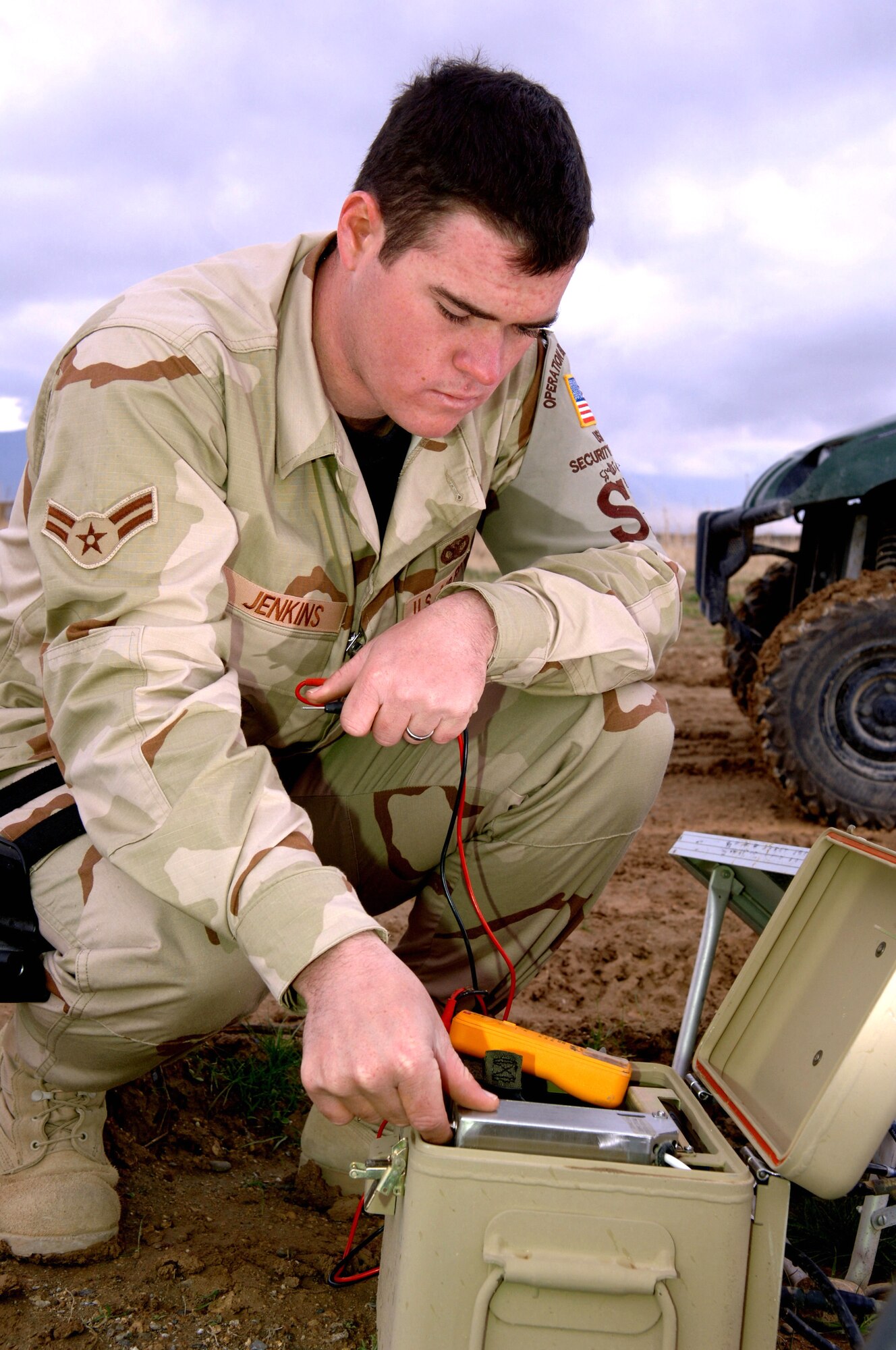 Airman 1st Class Justin Jenkins checks the power of the reserve battery module during a daily check of land mine sensors at Bagram Air Base, Afghanistan. Land mines were placed around Bagram during three decades of war by Russians, Taliban and Northern Alliance forces. Airman Jenkins is assigned to the 455th Expeditionary Security Forces Squadron as the tactical automated security systems administrator. He is deployed from Hickam Air Force Base, Hawaii. (U.S. Air Force photo/Staff Sgt. Jennifer Redente)