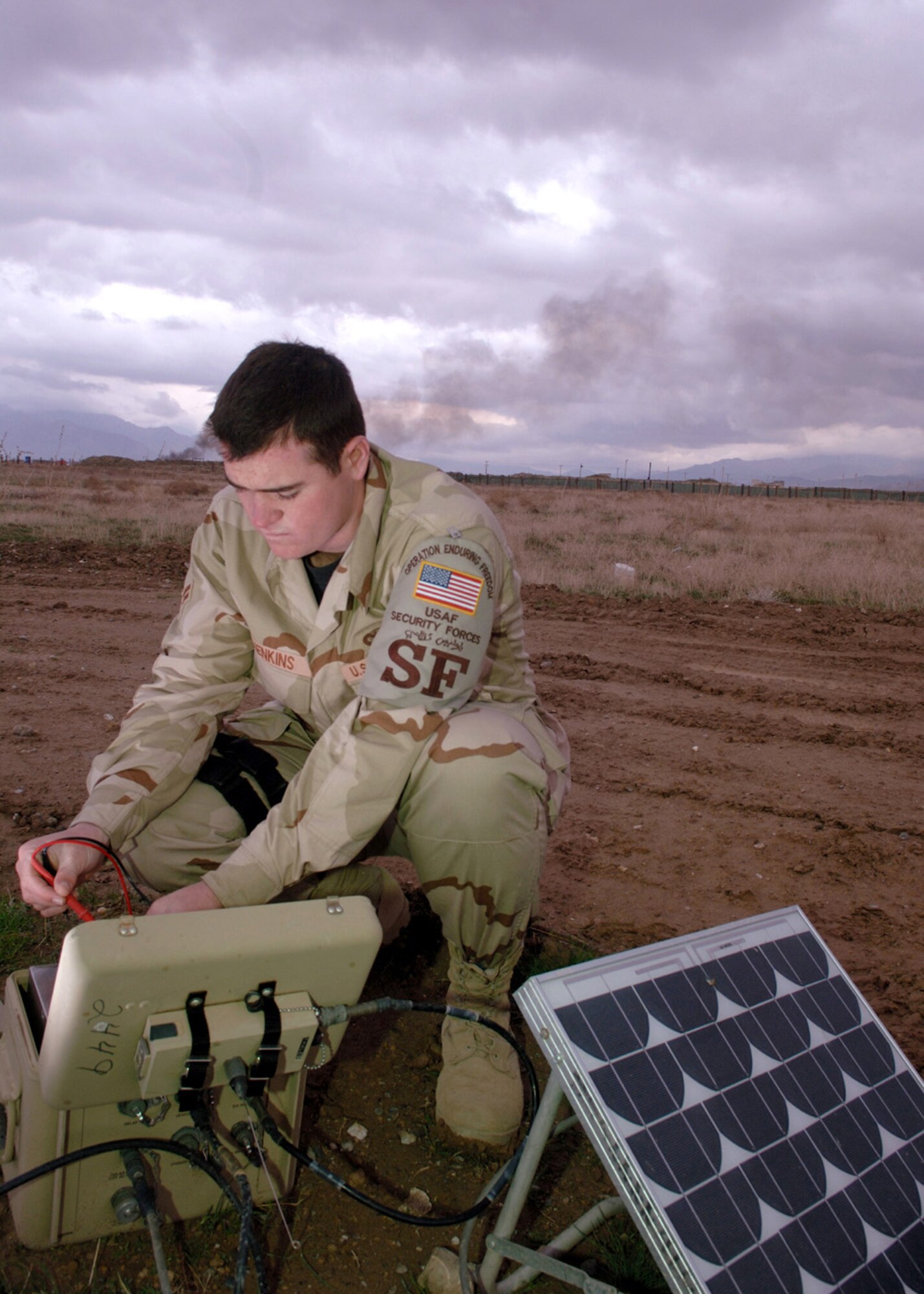 Airman 1st Class Justin Jenkins checks the power of the reserve battery module for land mine sensors near the flightline at Bagram Air Base, Afghanistan. Airman Jenkins is assigned to the 455th Expeditionary Security Forces Squadron as the tactical automated security systems administrator. He is deployed from Hickam Air Force Base, Hawaii. (U.S. Air Force photo/Staff Sgt. Jennifer Redente)