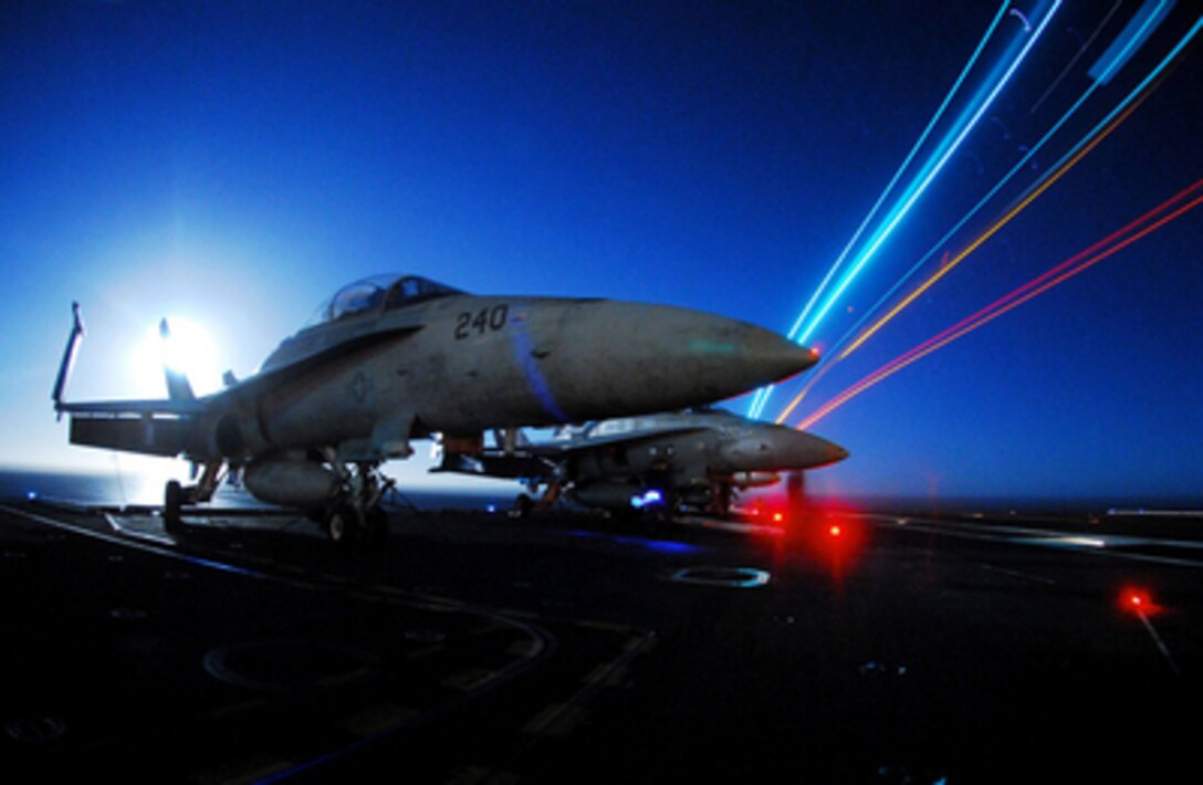 U.S. Marine Corps F/A-18C Hornet aircraft sit chained to the flight deck of the aircraft carrier USS John C. Stennis (CVN 74) as the ship operates at night in the Pacific Ocean on March 15, 2006. Stennis is conducting carrier qualifications off the coast of Southern California. 