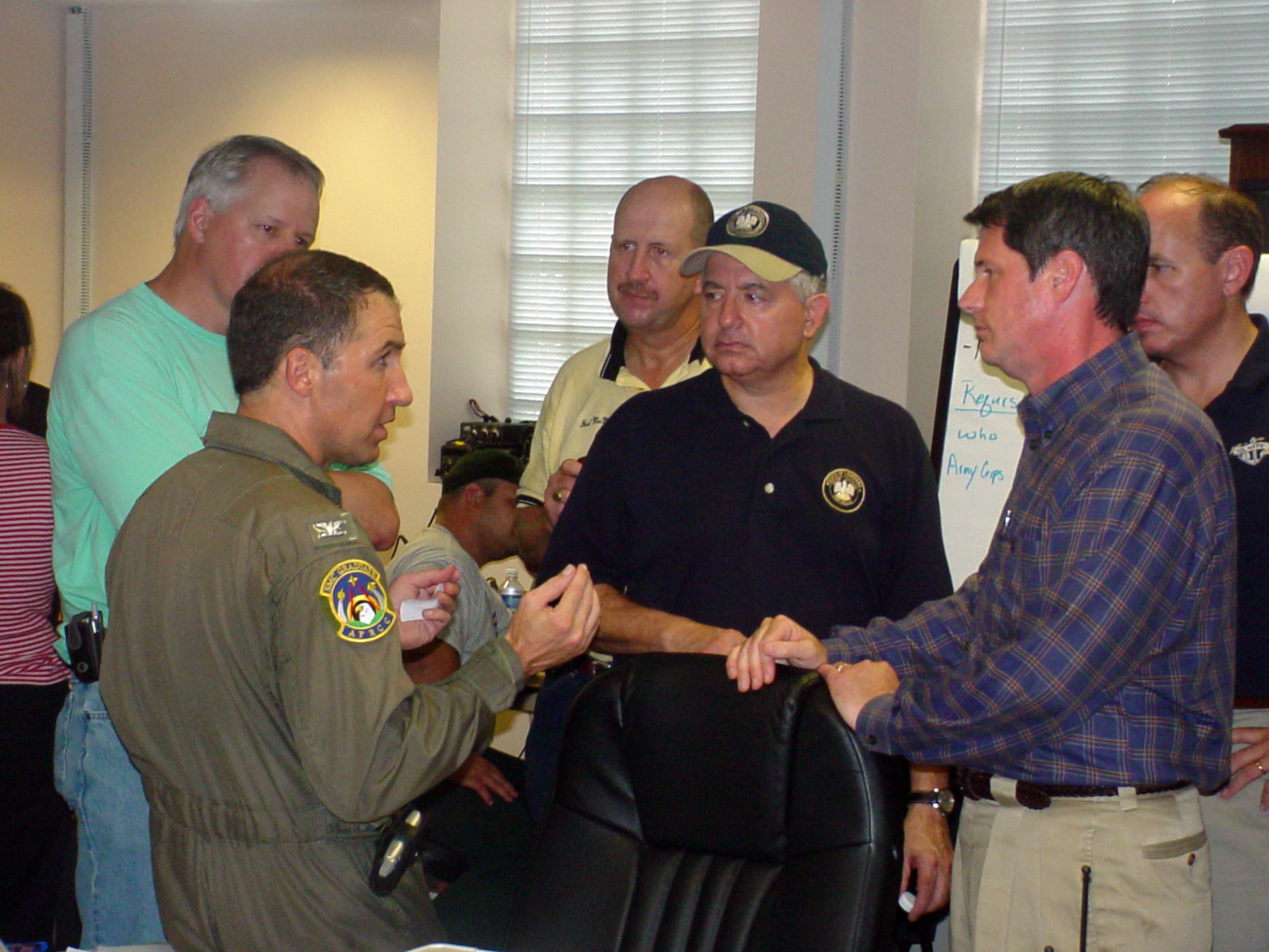 Civil Air Patrol Col. Rock Palermo discusses Hurricane Rita relief operations in Lake Charles, La., with Chuck Kleckley, Louisiana state representative; Hal McMillin, Calcasieu Parish police jury president; Ronnie Johns, Louisiana state representative; and David Vitter, U.S. senator from Louisiana. Colonel Palermo spent nearly three weeks directing local emergency operations in his hometown of Lake Charles. He was drafted as operations section chief and later deputy director because of his past disaster management experience. (U.S. Air Force photo/Tom R. Malmay Jr.) 