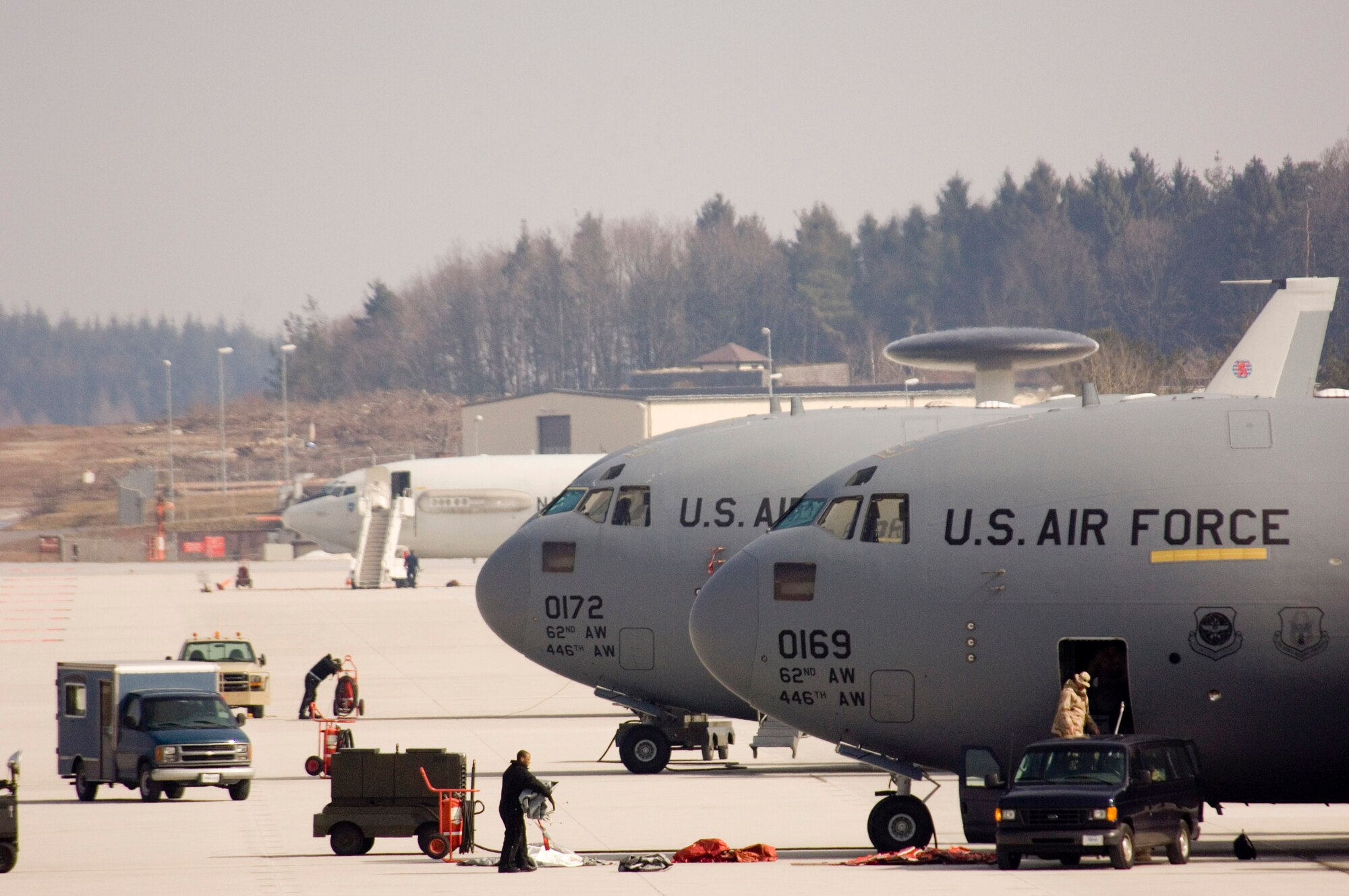 A pair of C-17 Globemaster IIIs and an E-3 Sentry (AWACS) sit on the tarmac at Spangdahlem Air Base, Germany, Wednesday, March 22, 2006. The transports, from McChord Air Force Base, Wash., and the NATO airborne warning and control system will receive services from Spangdahlem's 726th Air Mobility Squadron. (U.S. Air Force photo/Master Sgt. John E. Lasky)
